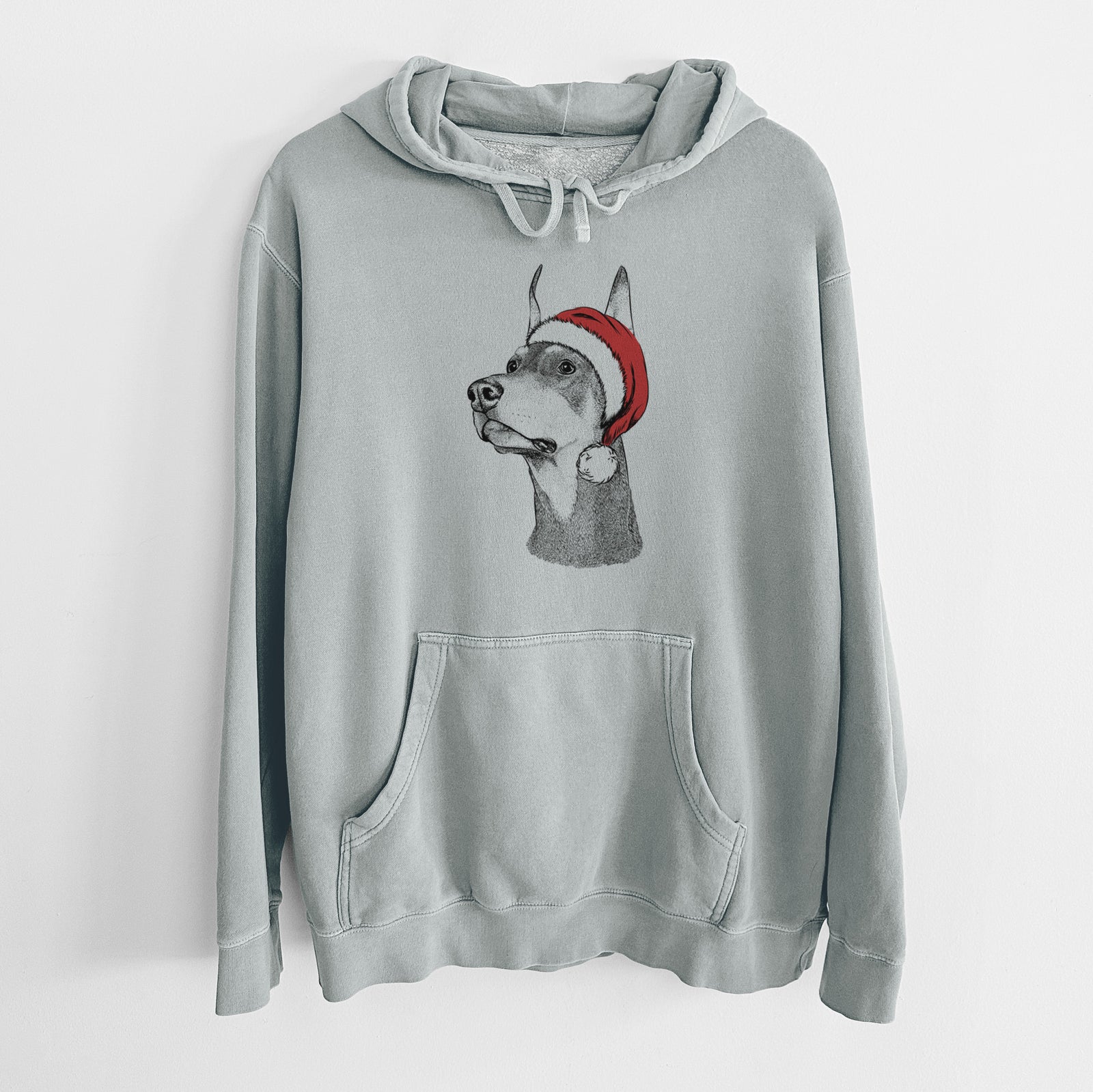 Hand-drawn sketch of Cenza the Doberman Pinscher wearing a Santa hat on a Sage Unisex pigment dyed hoodie