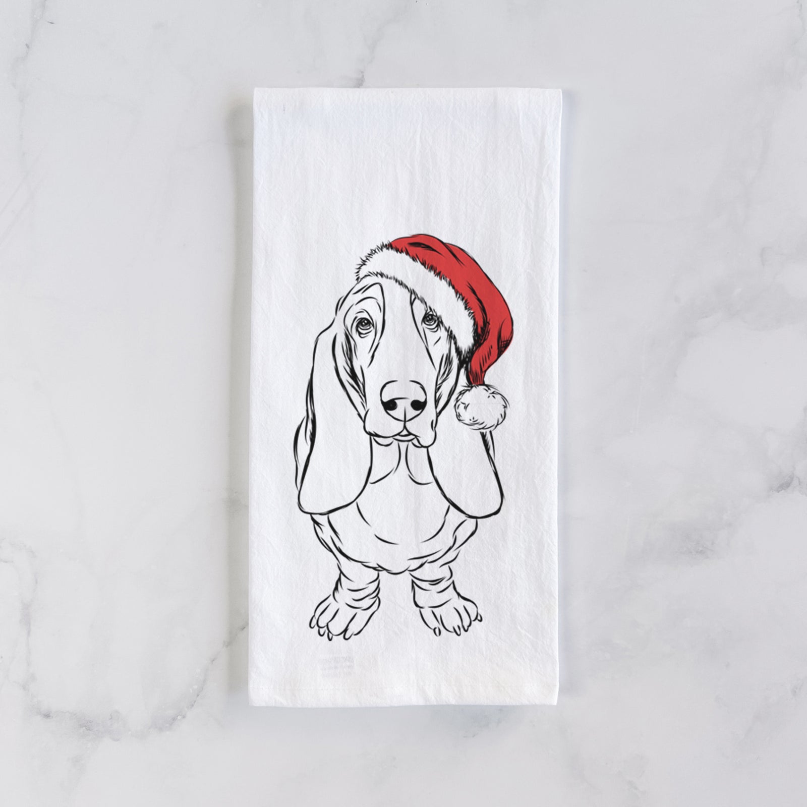 Hand-drawn sketch of Charlie the Basset Hound wearing a Santa hat on a tea towel