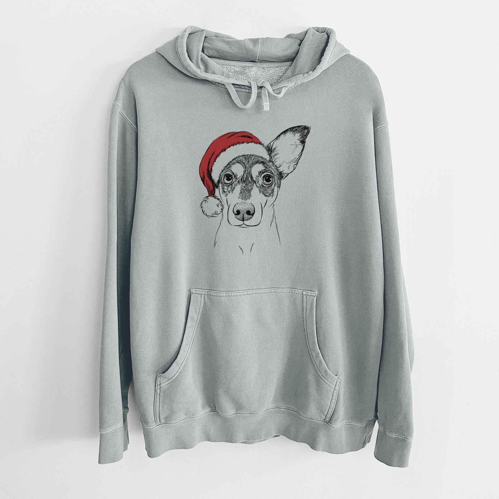 Hand-drawn sketch of Chloe the Doxie Mix wearing a Santa hat on a Sage Unisex pigment dyed hoodie