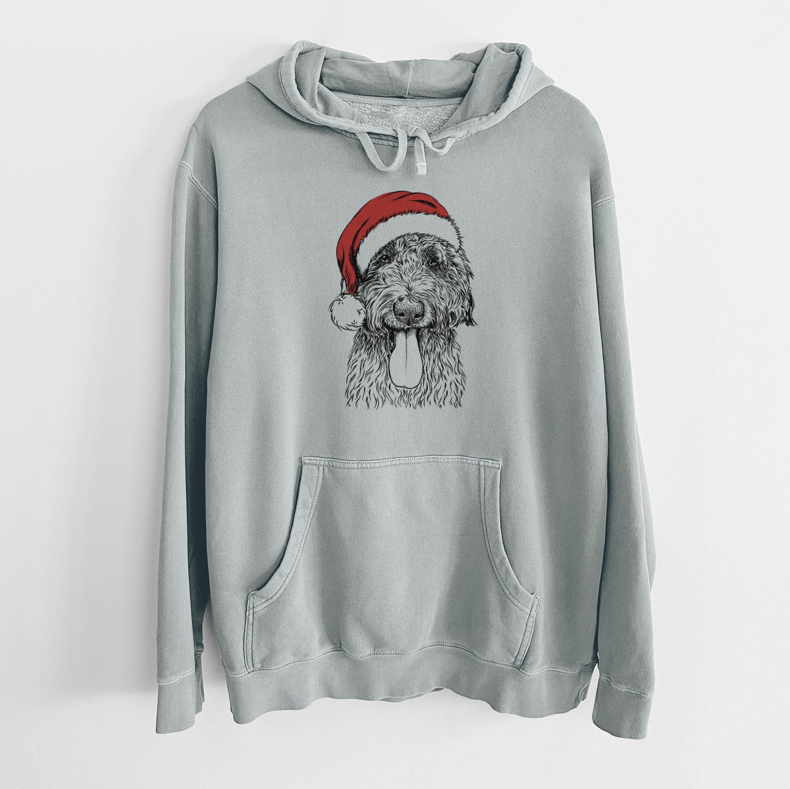 Hand-drawn sketch of CiCi Paulk the Aussiedoodle wearing a Santa hat on a Sage Unisex pigment dyed hoodie