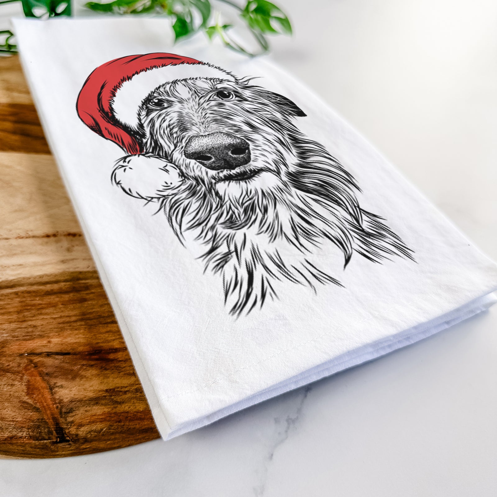 Hand-drawn sketch of Cleod the Scottish Deerhound wearing a Santa hat on a tea towel