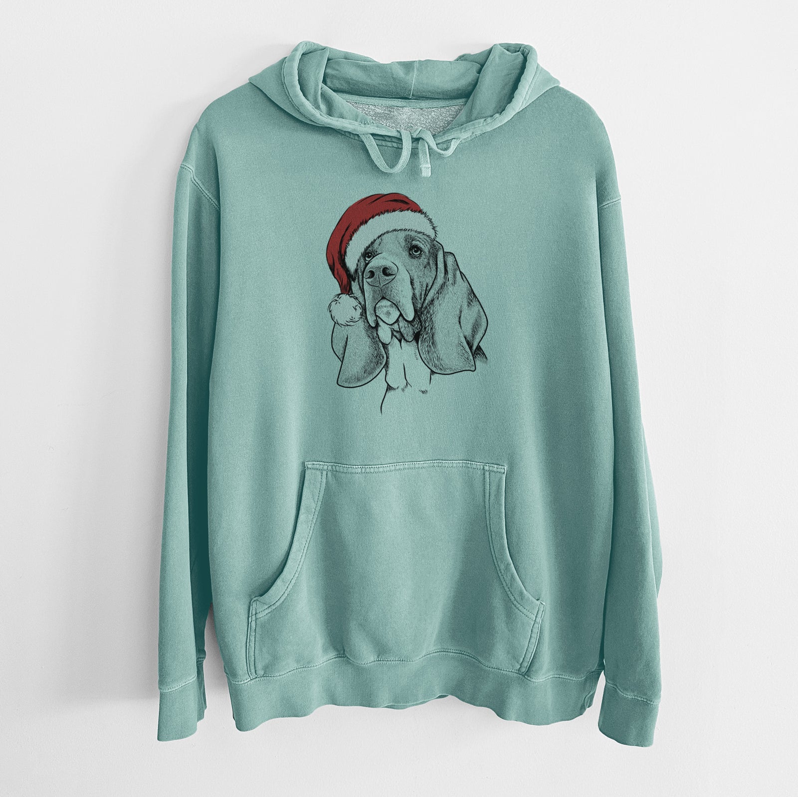 Hand-drawn sketch of Cooper the Basset Hound wearing a Santa hat on a Mint Unisex pigment dyed hoodie