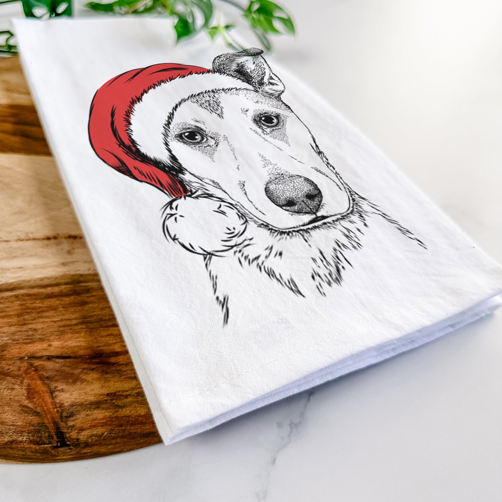 Hand-drawn sketch of Coral the Mixed Breed wearing a Santa hat on a tea towel