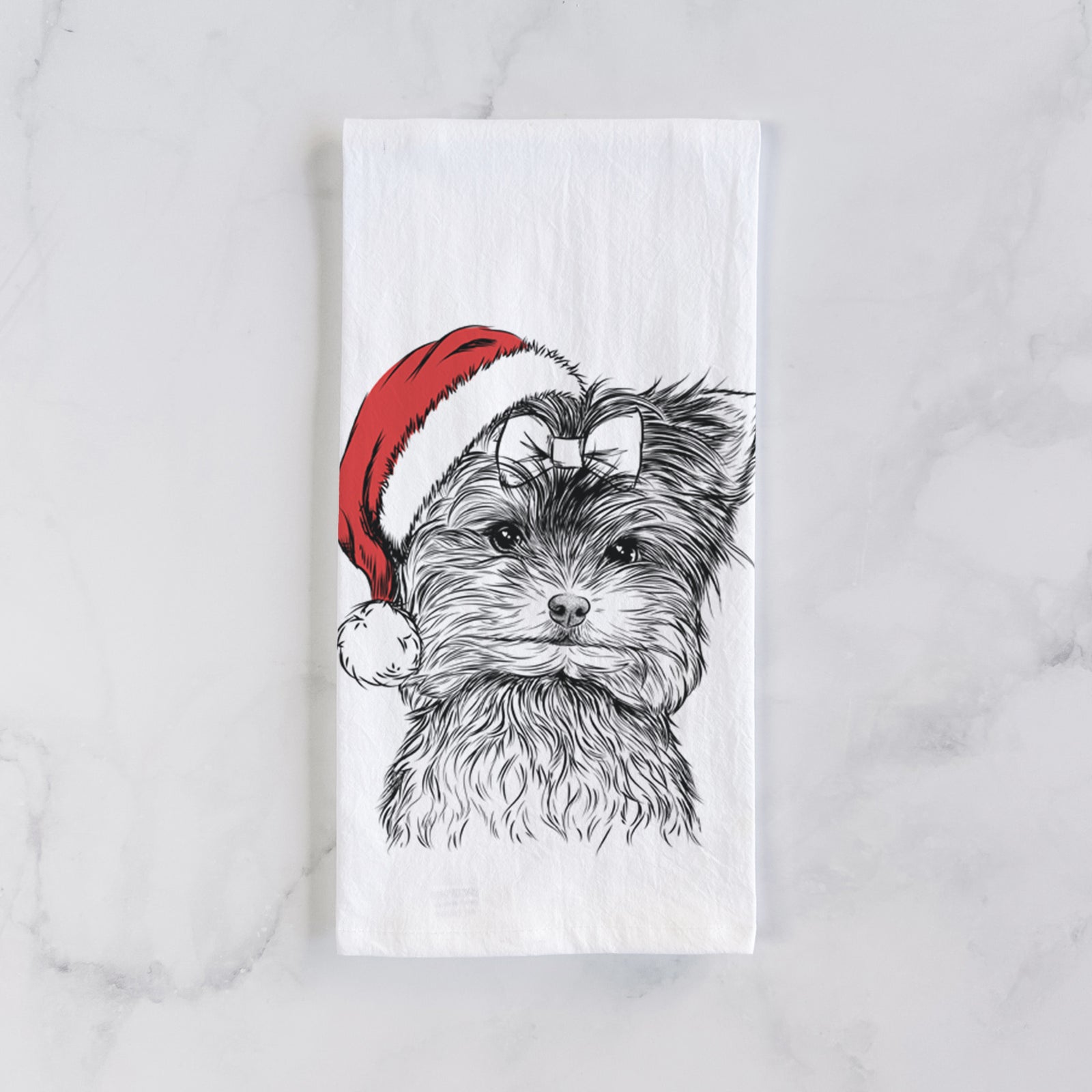 Hand-drawn sketch of Cricket the Biewer Terrier wearing a Santa hat on a tea towel