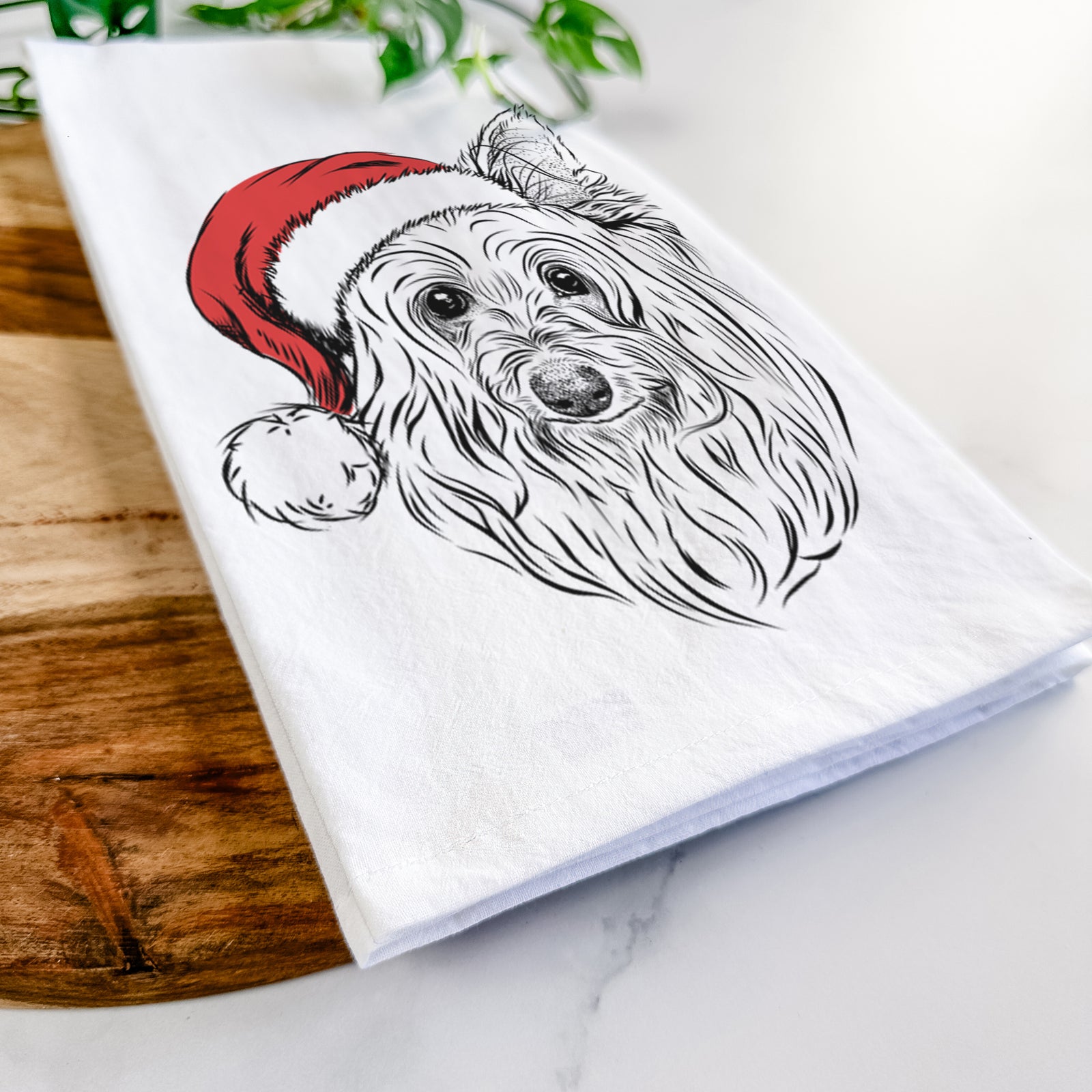 Hand-drawn sketch of Daisy May the Silky Terrier wearing a Santa hat on a tea towel