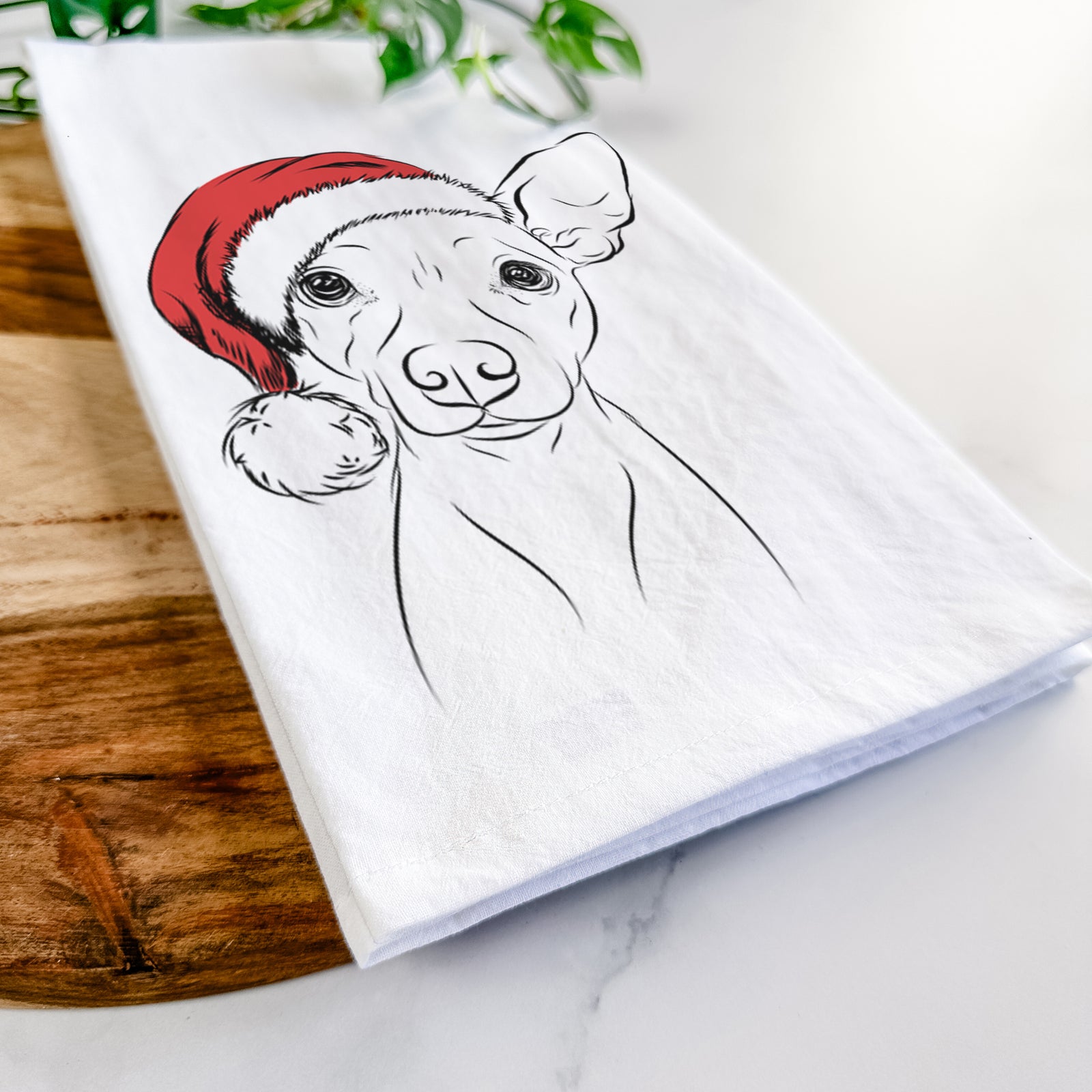 Hand-drawn sketch of Desi the American Hairless Terrier wearing a Santa hat on a tea towel