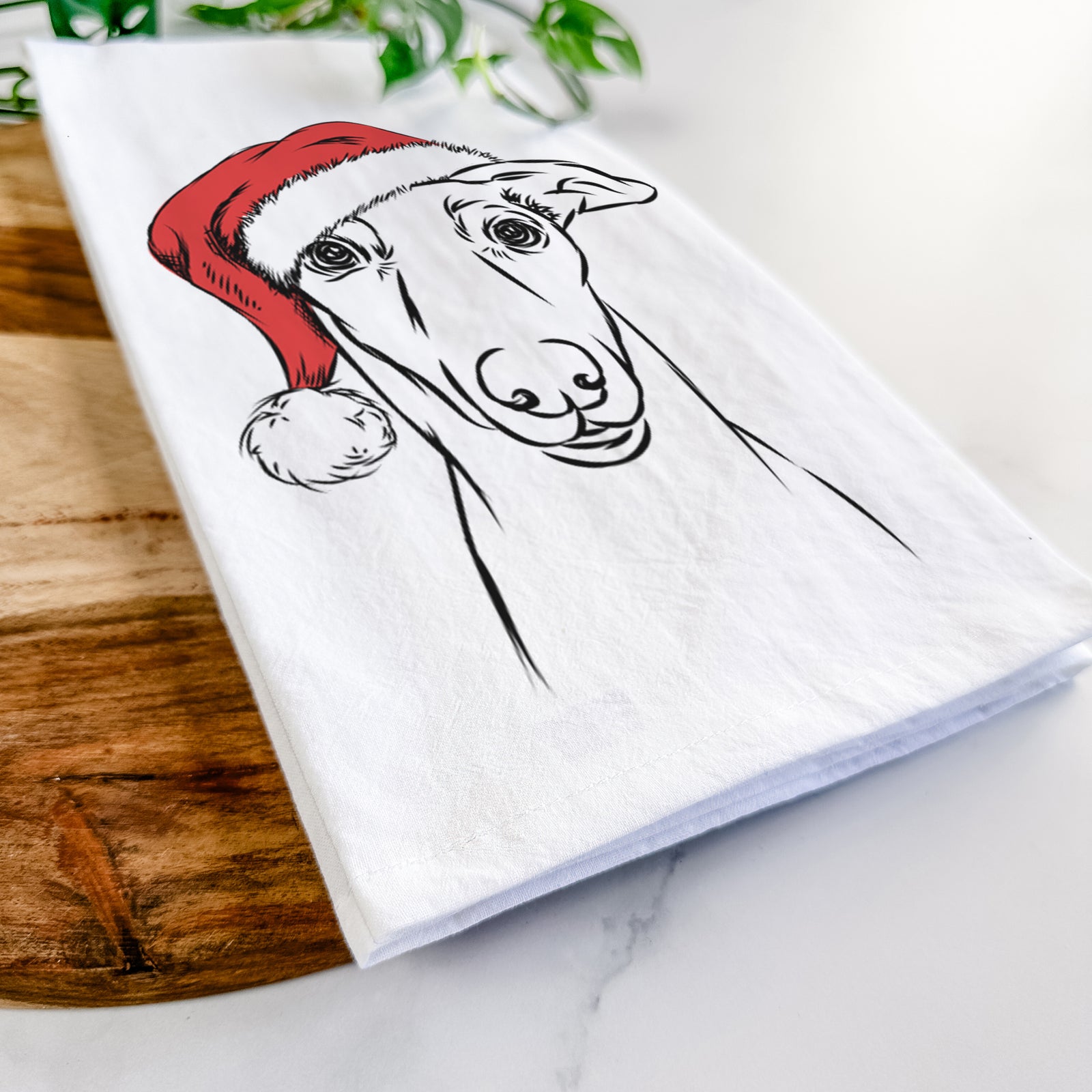 Hand-drawn sketch of Diva the Greyhound wearing a Santa hat on a tea towel