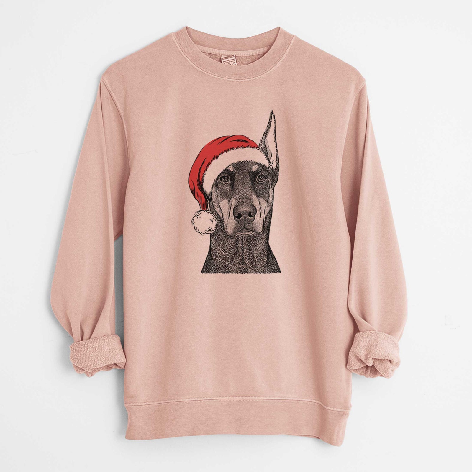 Hand-drawn sketch of Drake the Doberman Pinscher wearing a Santa hat on a Dusty Pink Unisex pigment dyed crew sweatshirt