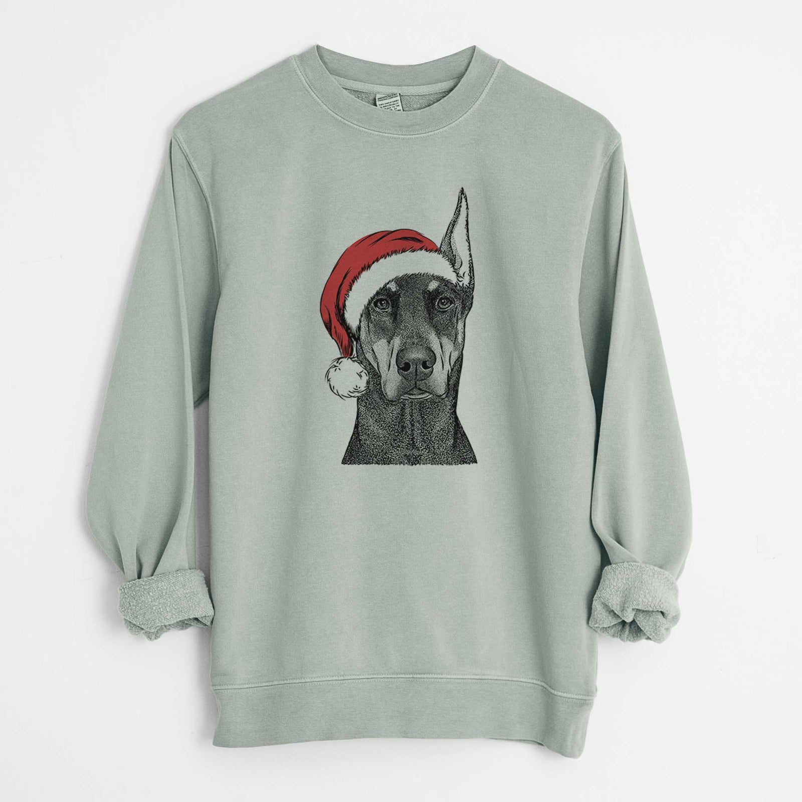 Hand-drawn sketch of Drake the Doberman Pinscher wearing a Santa hat on a Sage Unisex pigment dyed crew sweatshirt