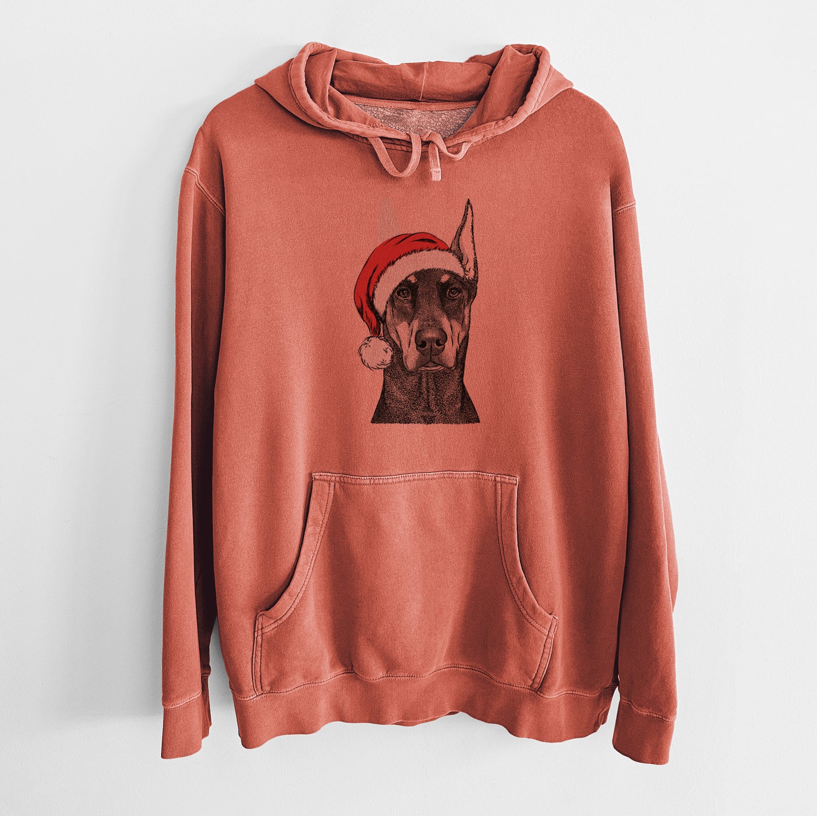 Hand-drawn sketch of Drake the Doberman Pinscher wearing a Santa hat on an Amber Unisex pigment dyed hoodie