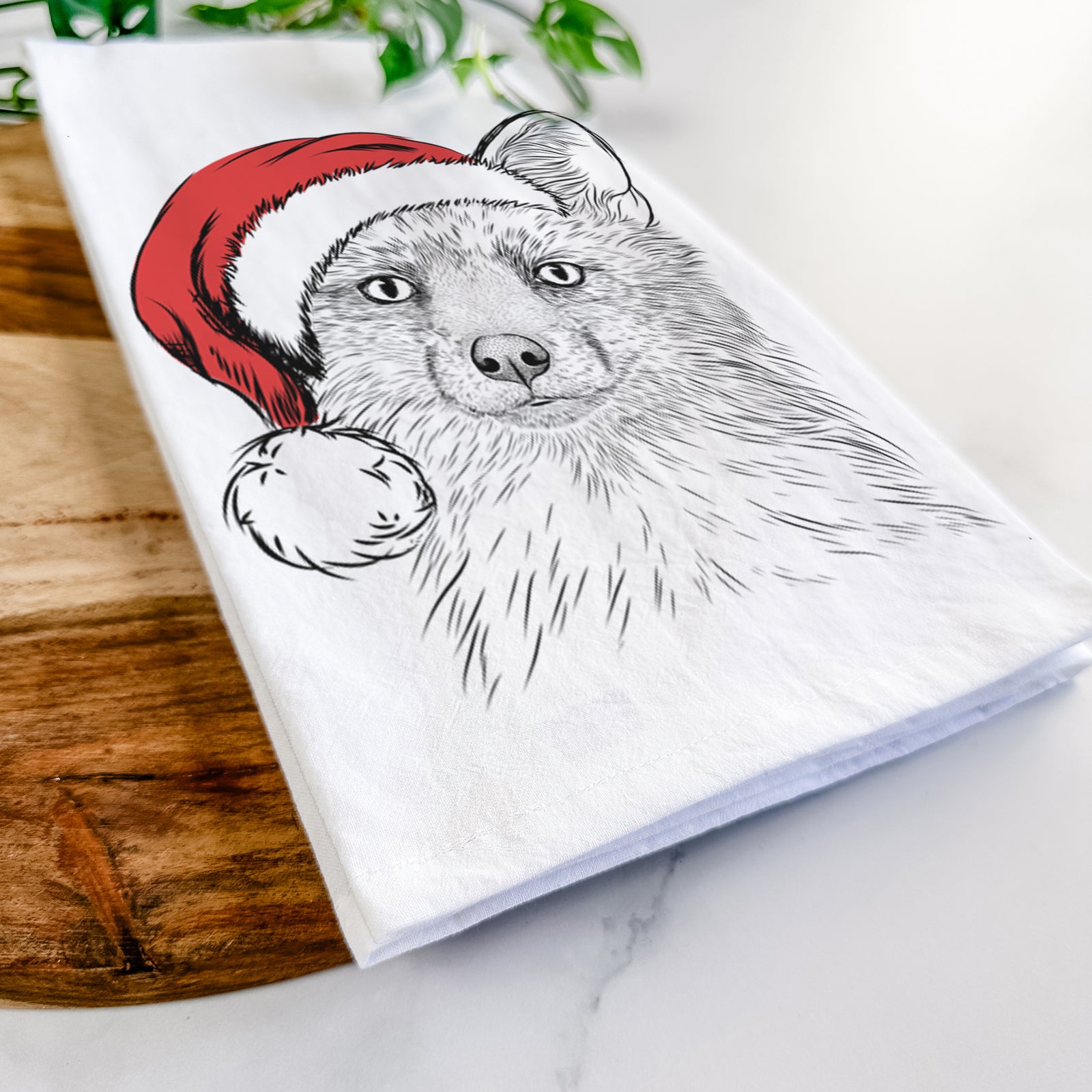Hand-drawn sketch of Drax the Red Fox wearing a Santa hat on a tea towel