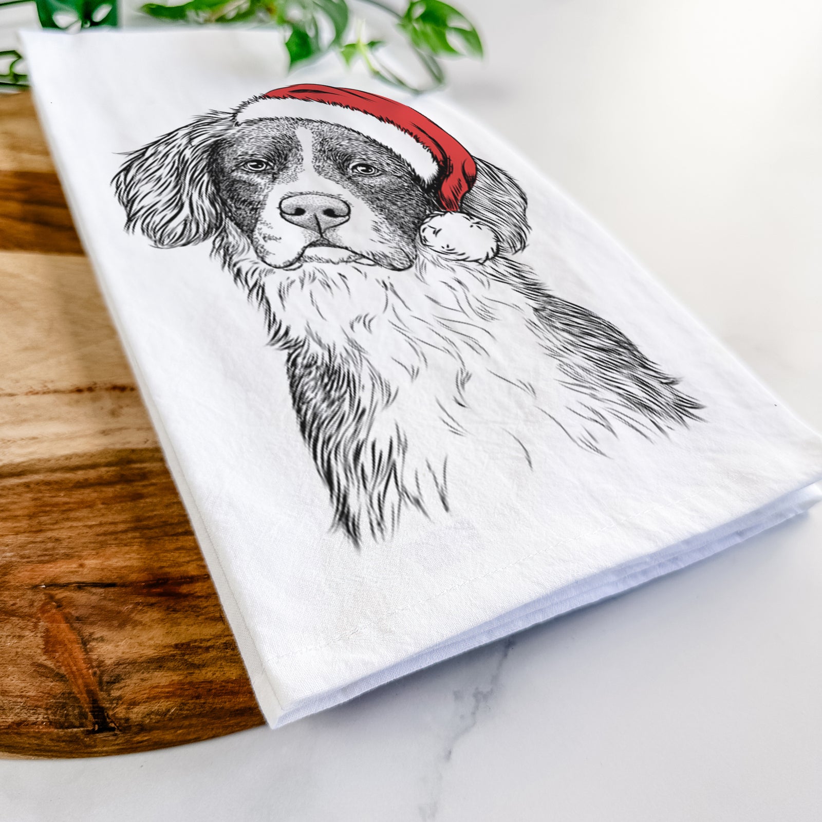 Hand-drawn sketch of Dulce the Drentsche Patrijshond wearing a Santa hat on a tea towel
