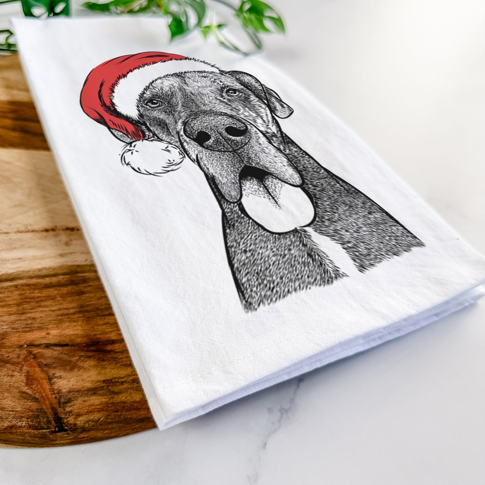 Hand-drawn sketch of Eli the Great Dane wearing a Santa hat on a tea towel