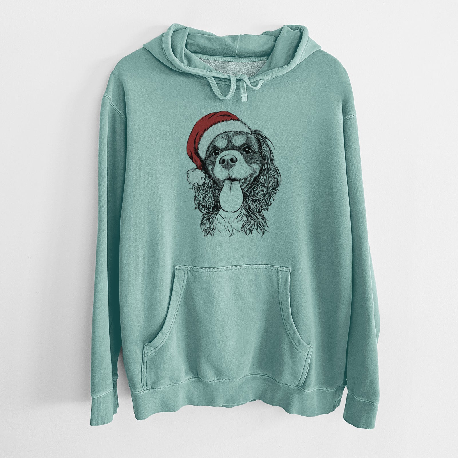 Hand-drawn sketch of Elizabeth the Cavalier King Charles Spaniel wearing a Santa hat on a Mint Unisex pigment dyed hoodie