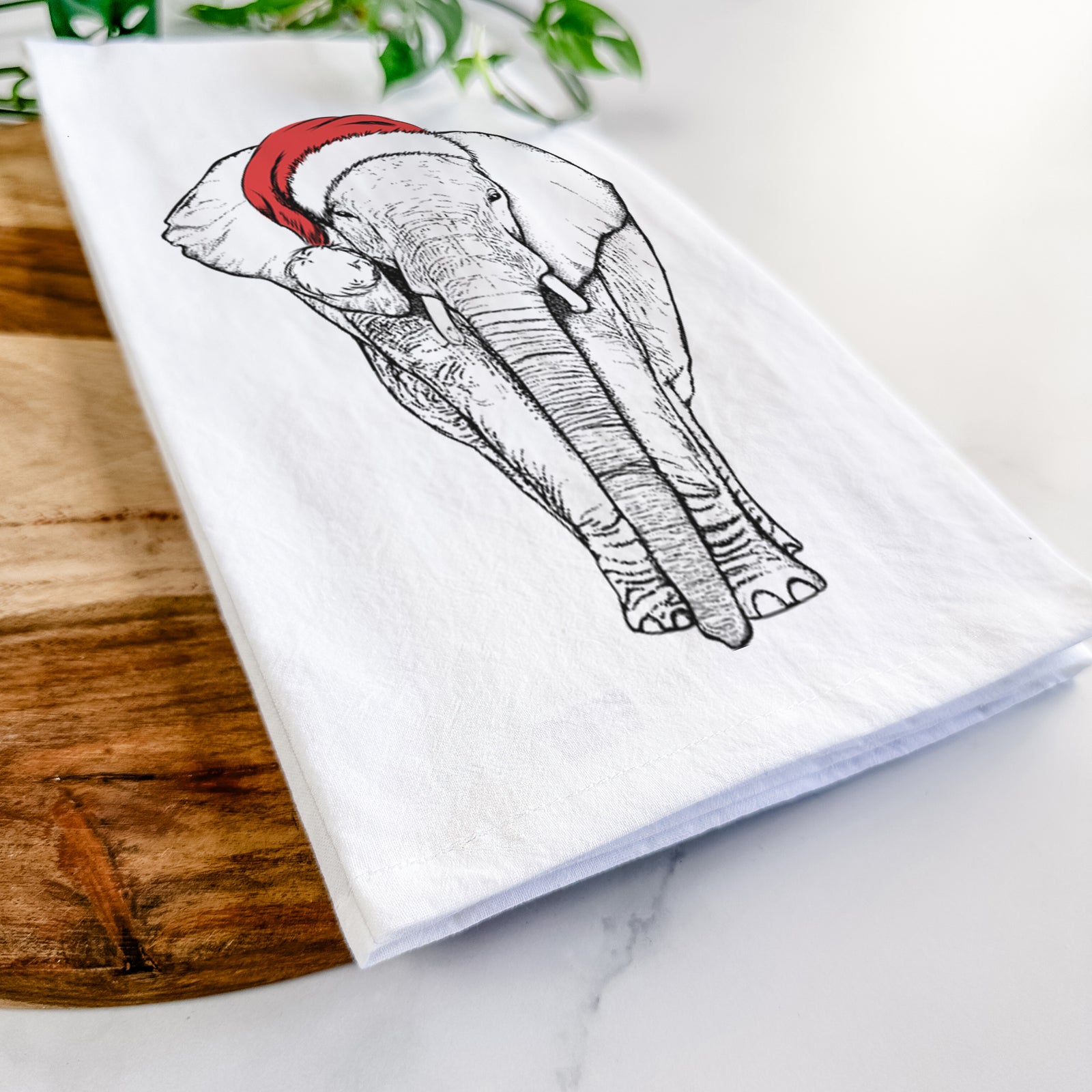 Hand-drawn sketch of Ella the Elephant wearing a Santa hat on a tea towel