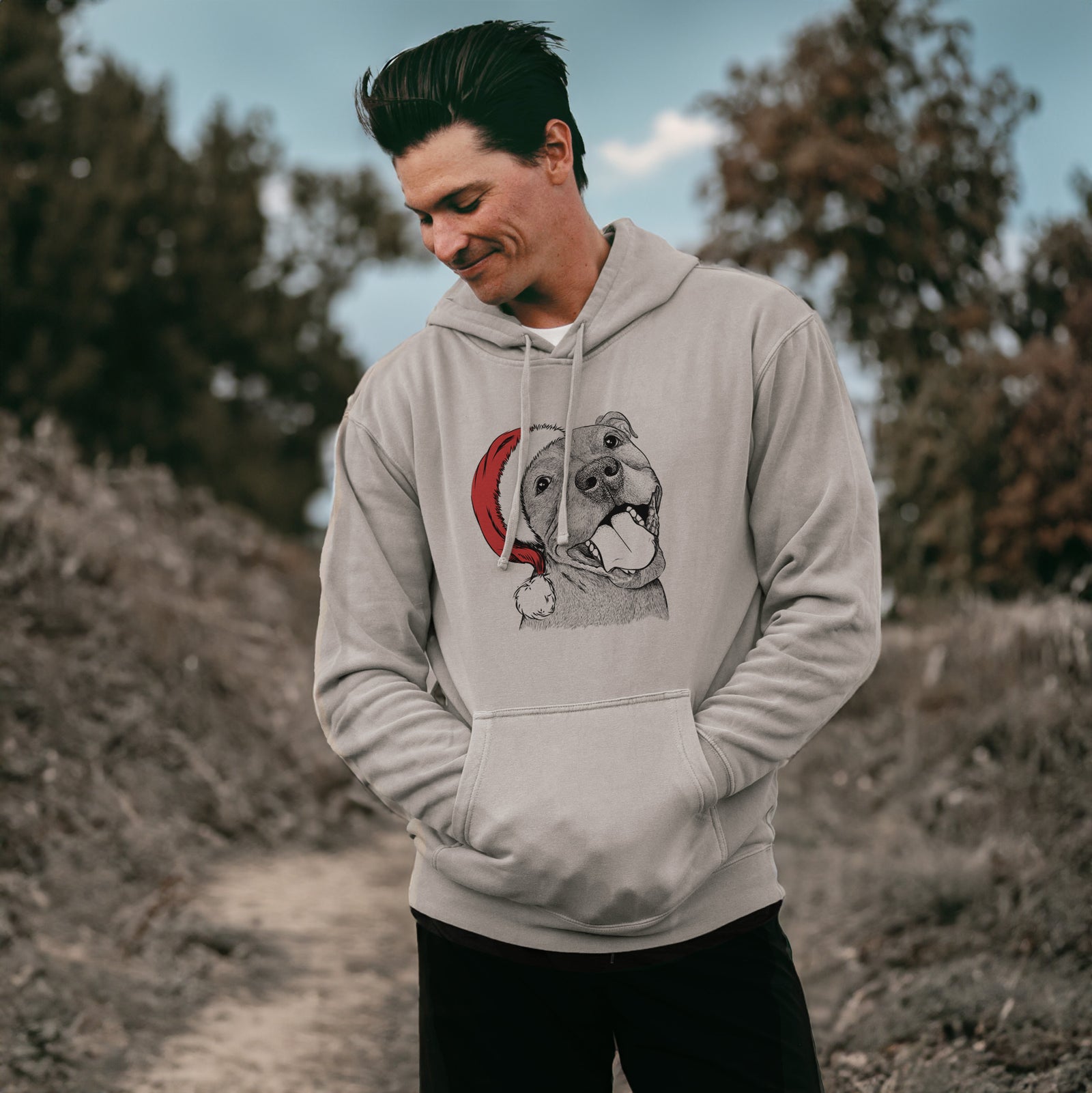 Hand-drawn sketch of Eloise the Pitbull Mix wearing a Santa hat on a Cement Unisex pigment dyed hoodie, worn by a man