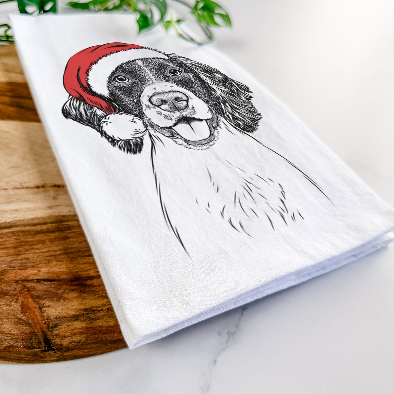 Hand-drawn sketch of Ever the English Springer Spaniel wearing a Santa hat on a tea towel