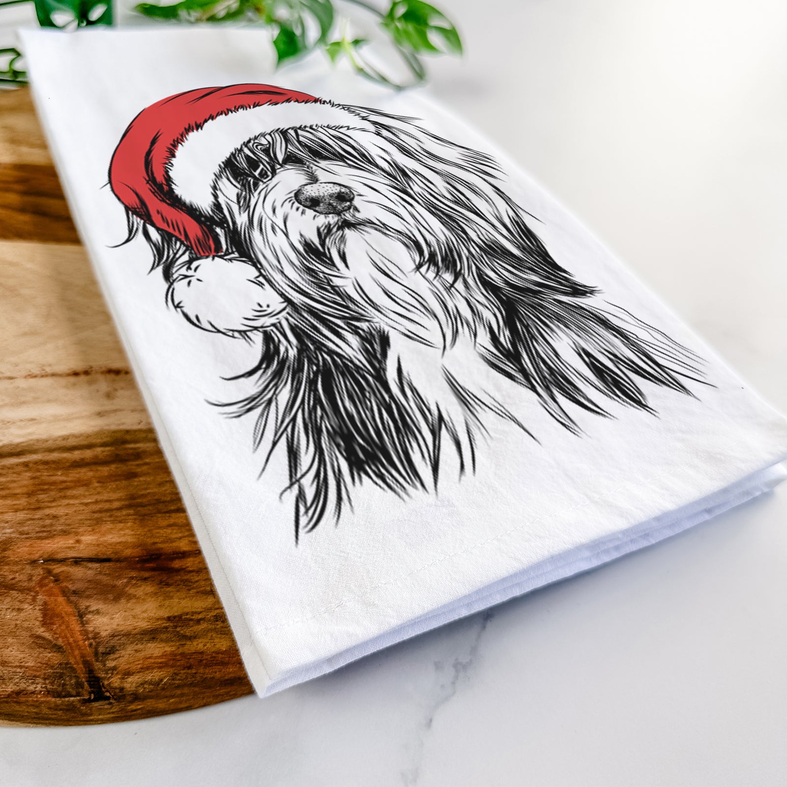 Hand-drawn sketch of Fiji the Polish Lowland Sheepdog wearing a Santa hat on a tea towel