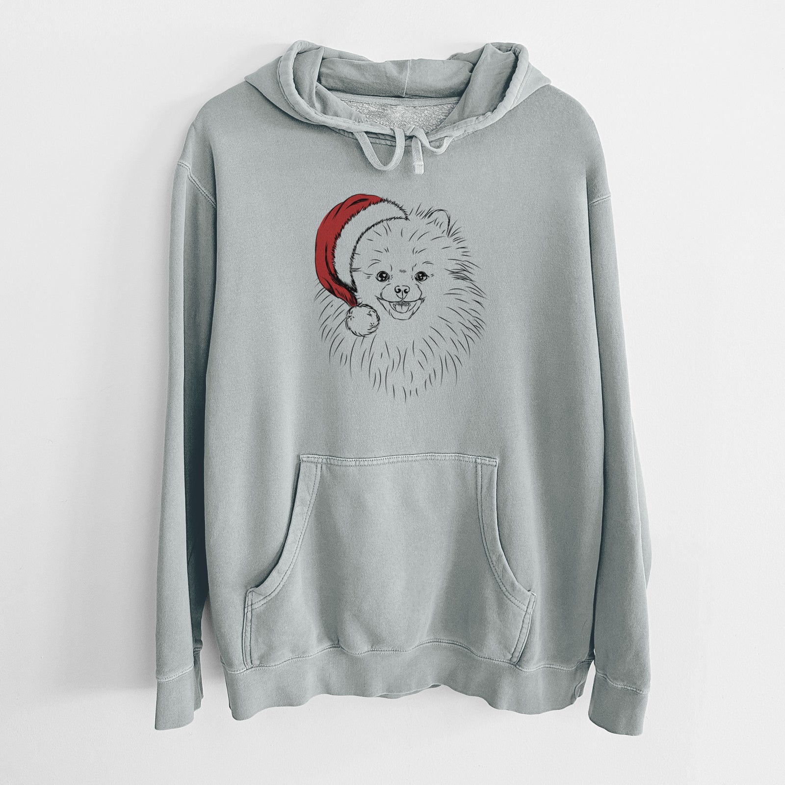 Hand-drawn sketch of Finn the Pomeranian wearing a Santa hat on a Sage Unisex pigment dyed hoodie