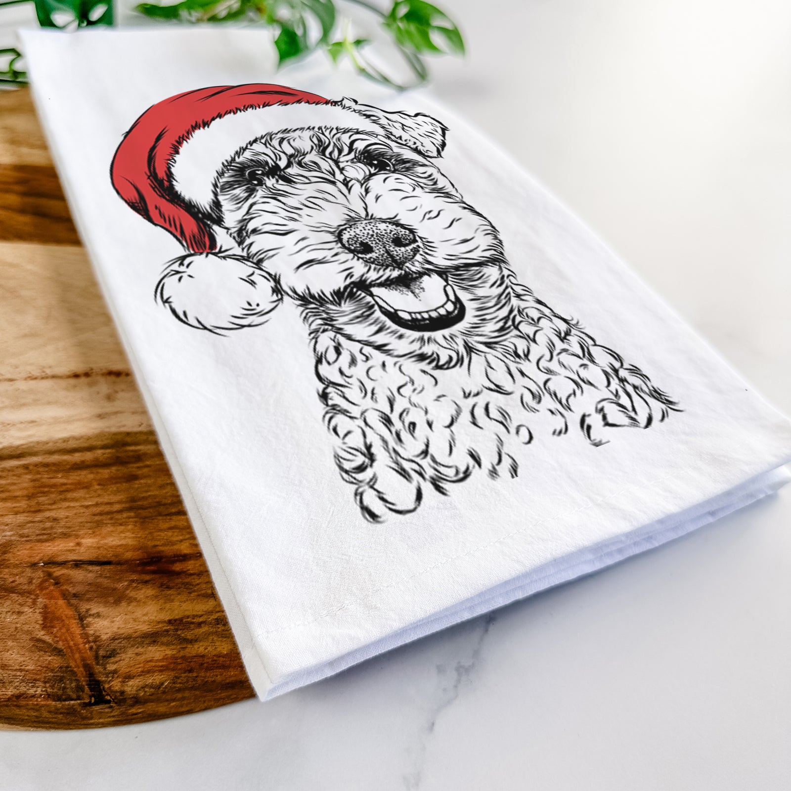 Hand-drawn sketch of Fintan the Irish Troodle wearing a Santa hat on a tea towel
