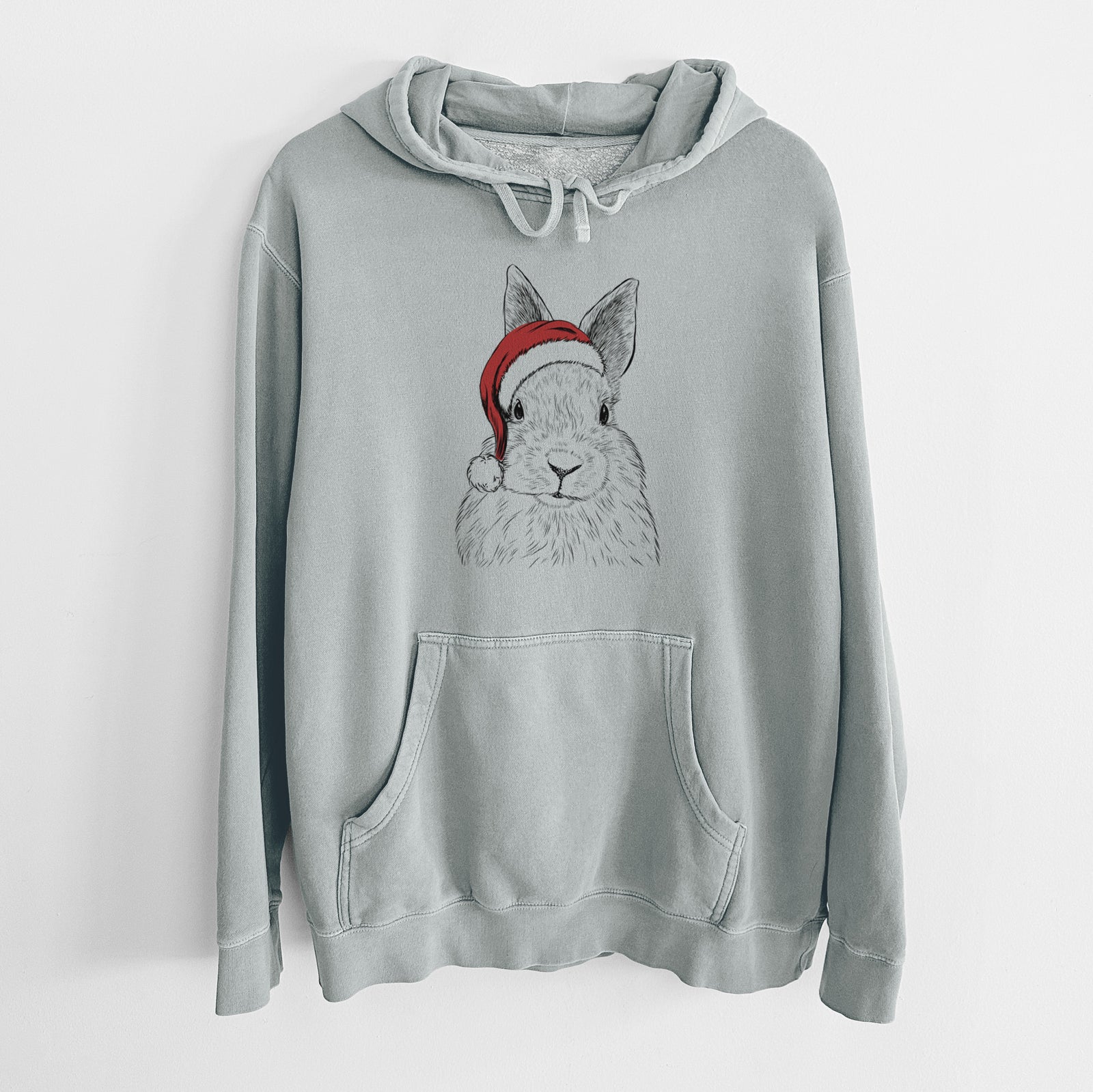 Hand-drawn sketch of Flower the Rex Rabbit wearing a Santa hat on a Sage Unisex pigment dyed hoodie