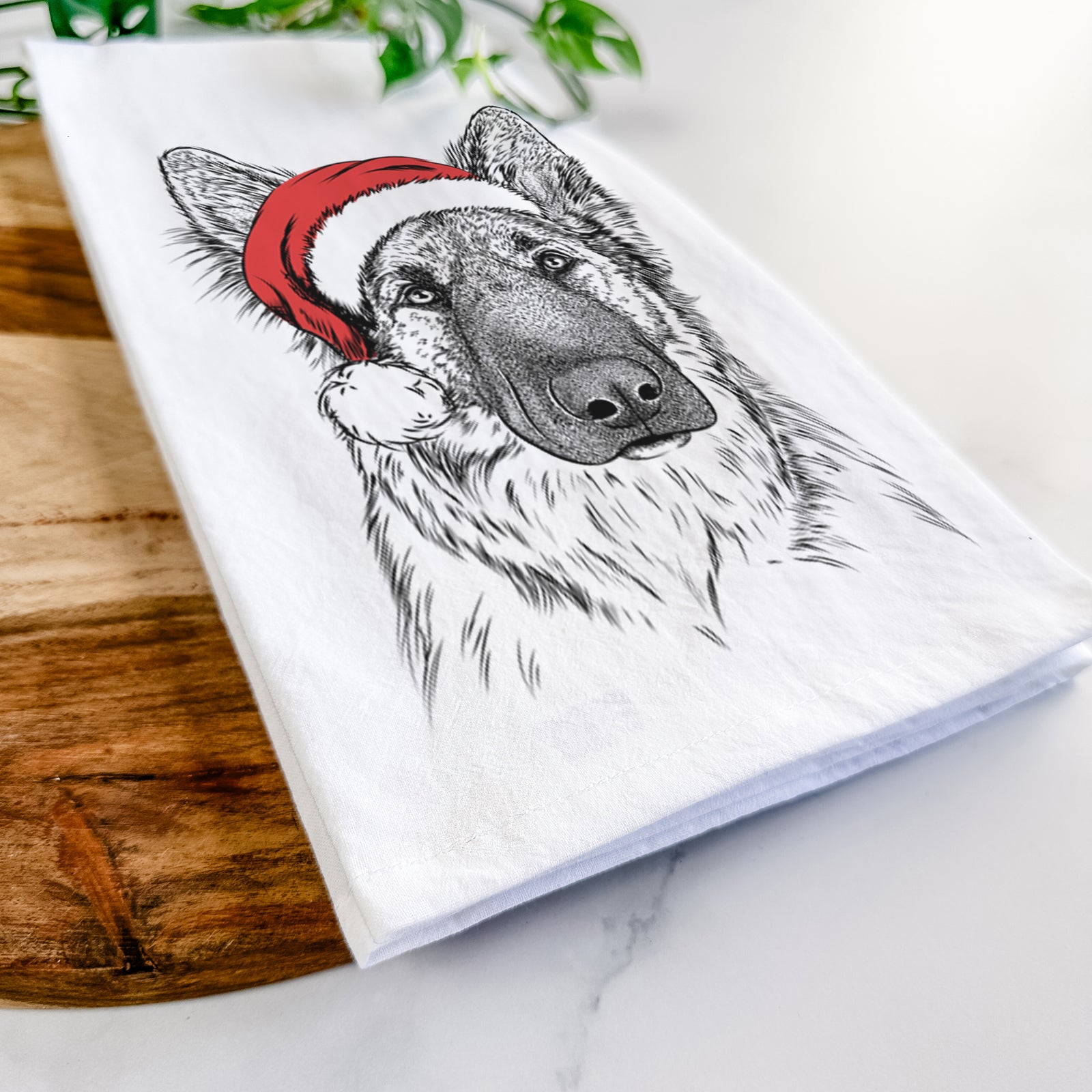 Hand-drawn sketch of Geddy the Shiloh Shepherd wearing a Santa hat on a tea towel