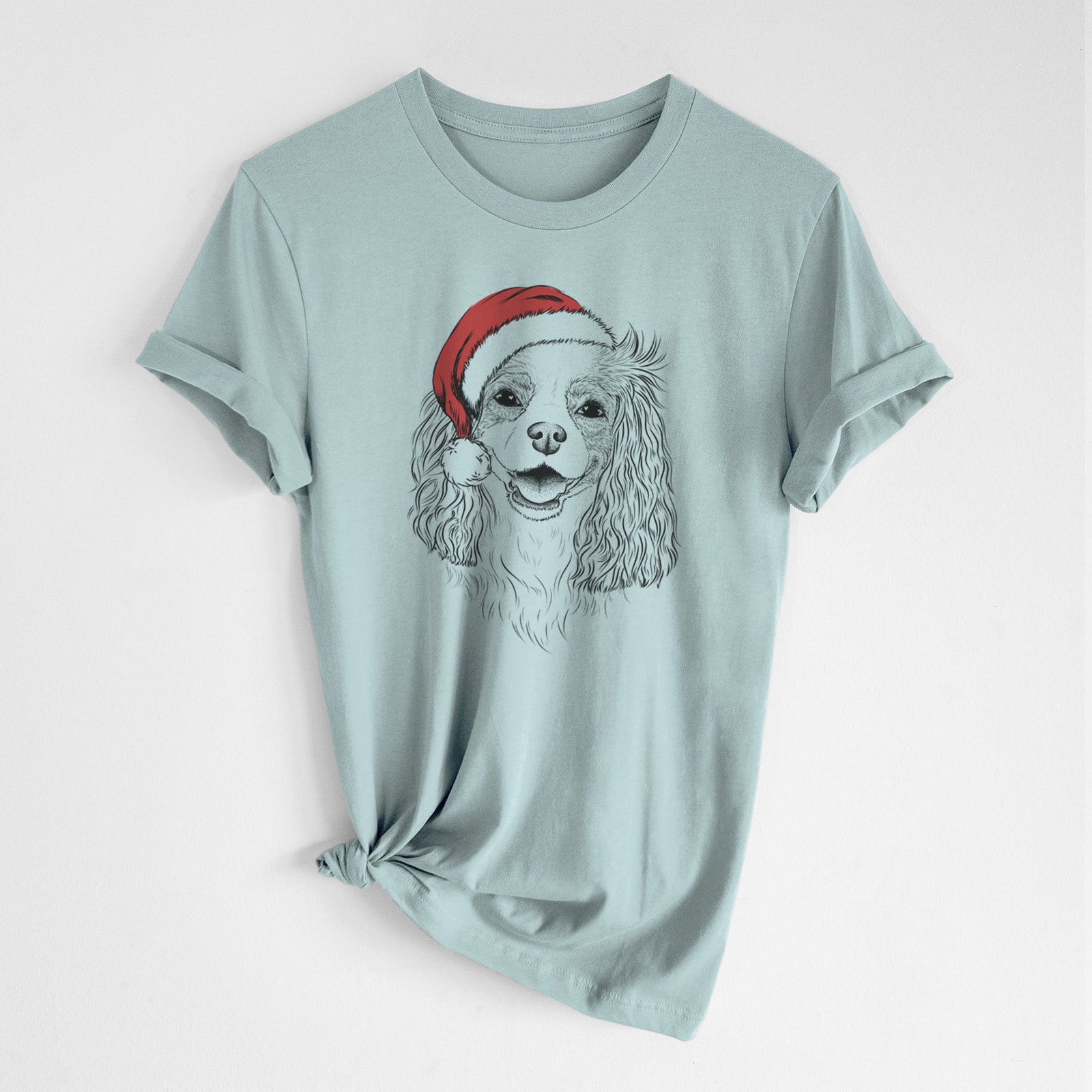 Hand-drawn sketch of Halley Comet the Cavalier King Charles Spaniel wearing a Santa hat on a Dusty Blue Unisex crewneck, worn by a woman