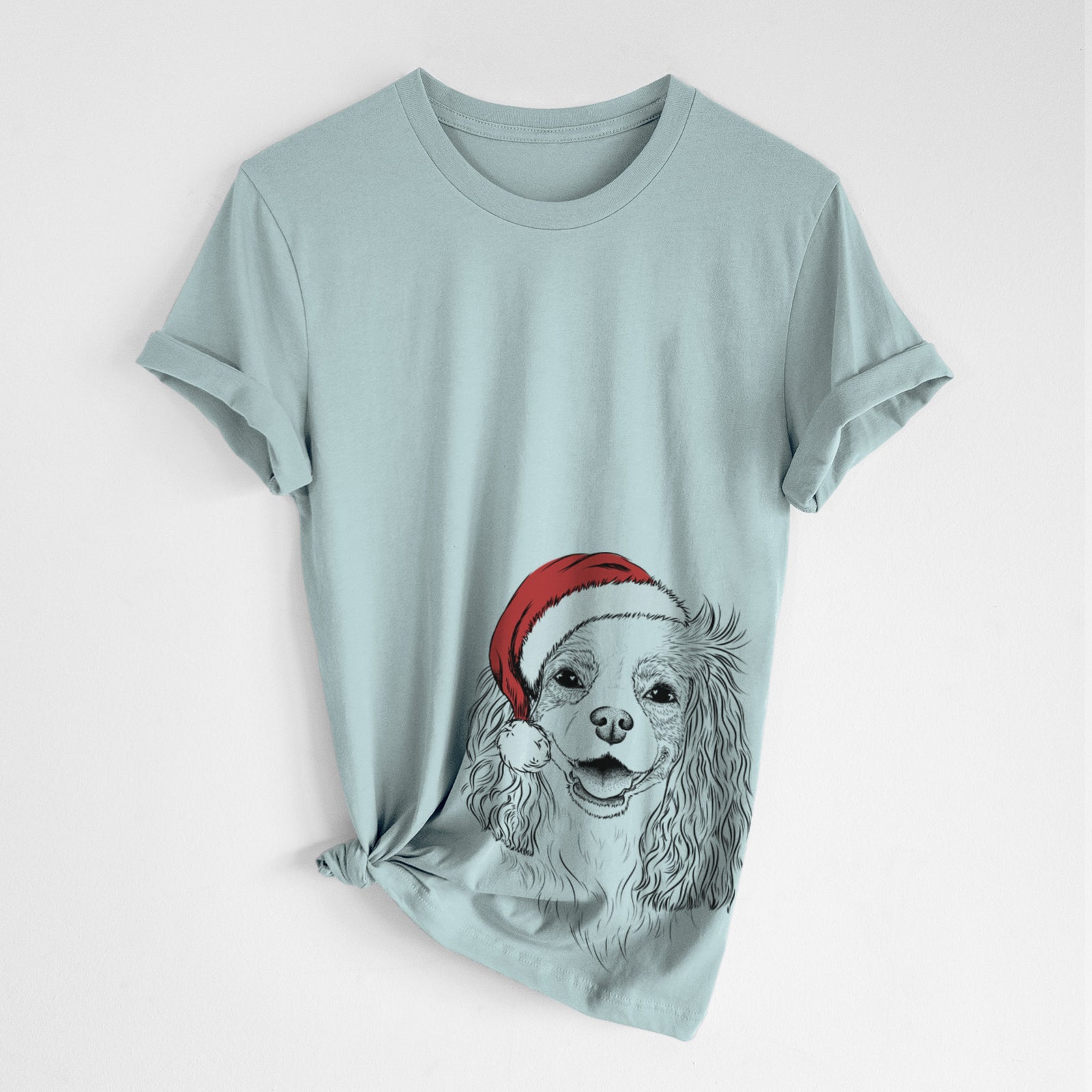 Hand-drawn sketch of Halley Comet the Cavalier King Charles Spaniel wearing a Santa hat on a Dusty Blue Unisex crewneck, worn by a woman