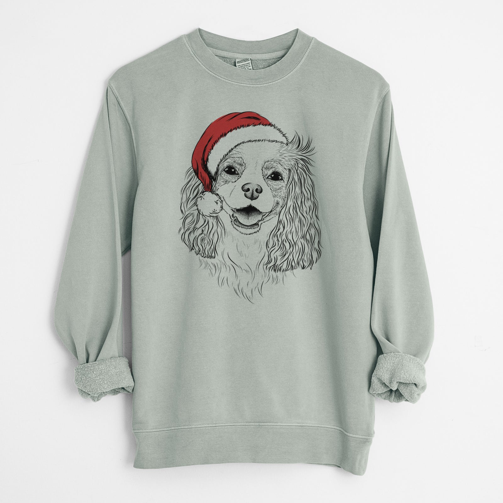 Hand-drawn sketch of Halley Comet the Cavalier King Charles Spaniel wearing a Santa hat on a Sage Unisex pigment dyed crew sweatshirt