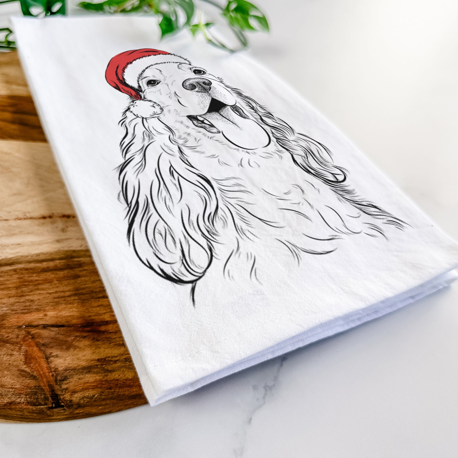 Hand-drawn sketch of Happy Henry the English Cocker Spaniel wearing a Santa hat on a tea towel