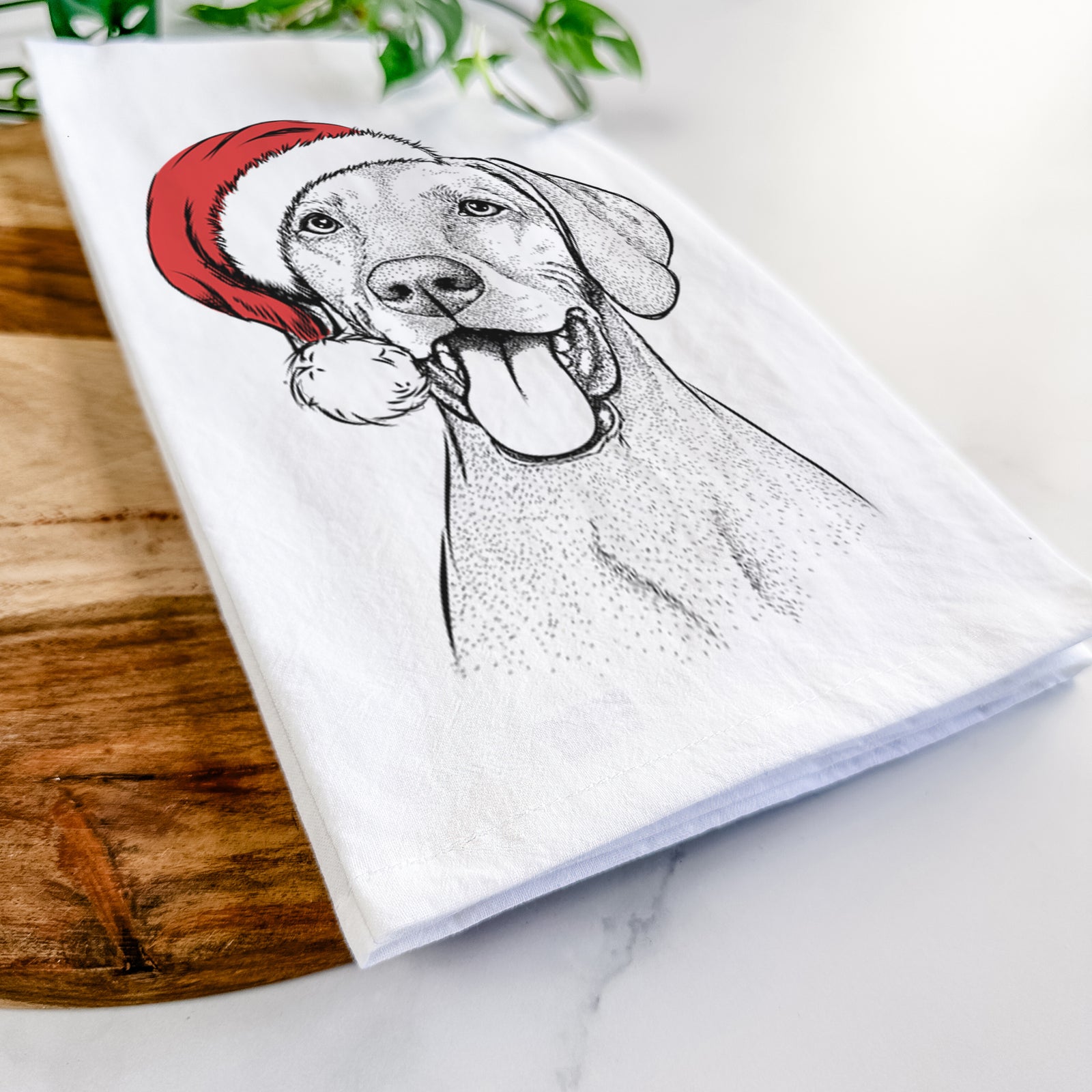 Hand-drawn sketch of Harper the Vizsla wearing a Santa hat on a tea towel