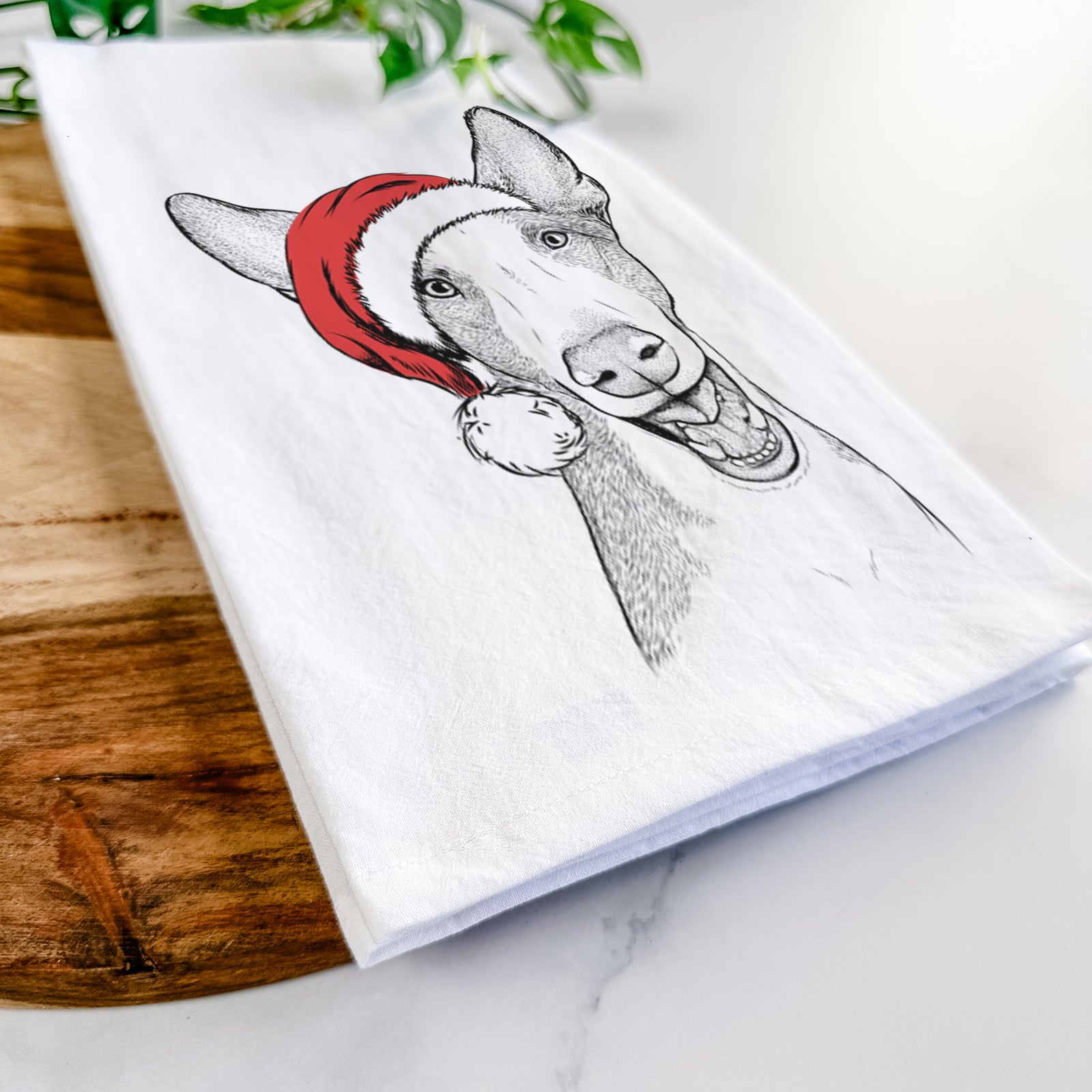 Hand-drawn sketch of Havok the Ibizan Hound wearing a Santa hat on a tea towel