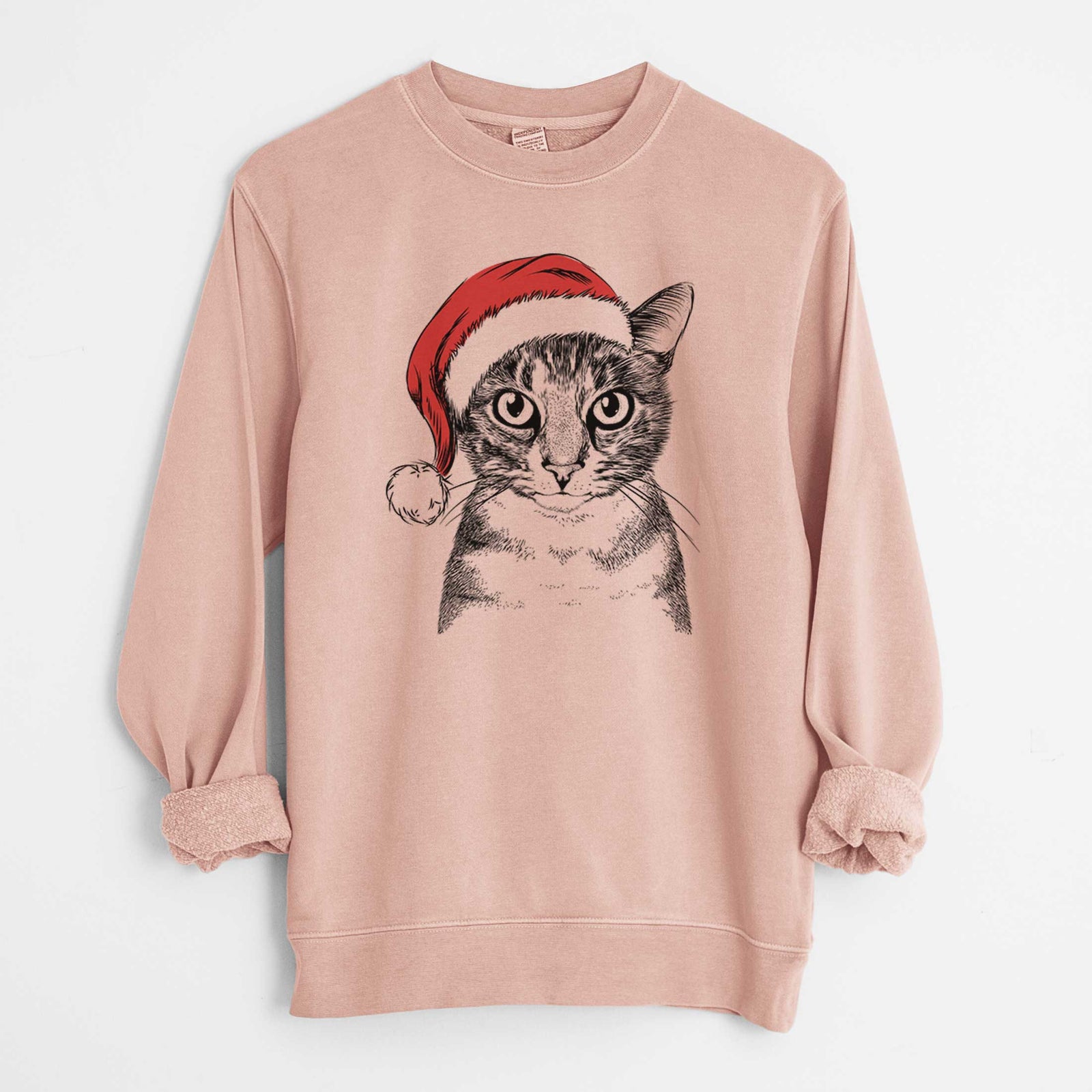 Hand-drawn sketch of Hobbes the Tabby Cat wearing a Santa hat on a Dusty Pink Unisex pigment dyed crew sweatshirt