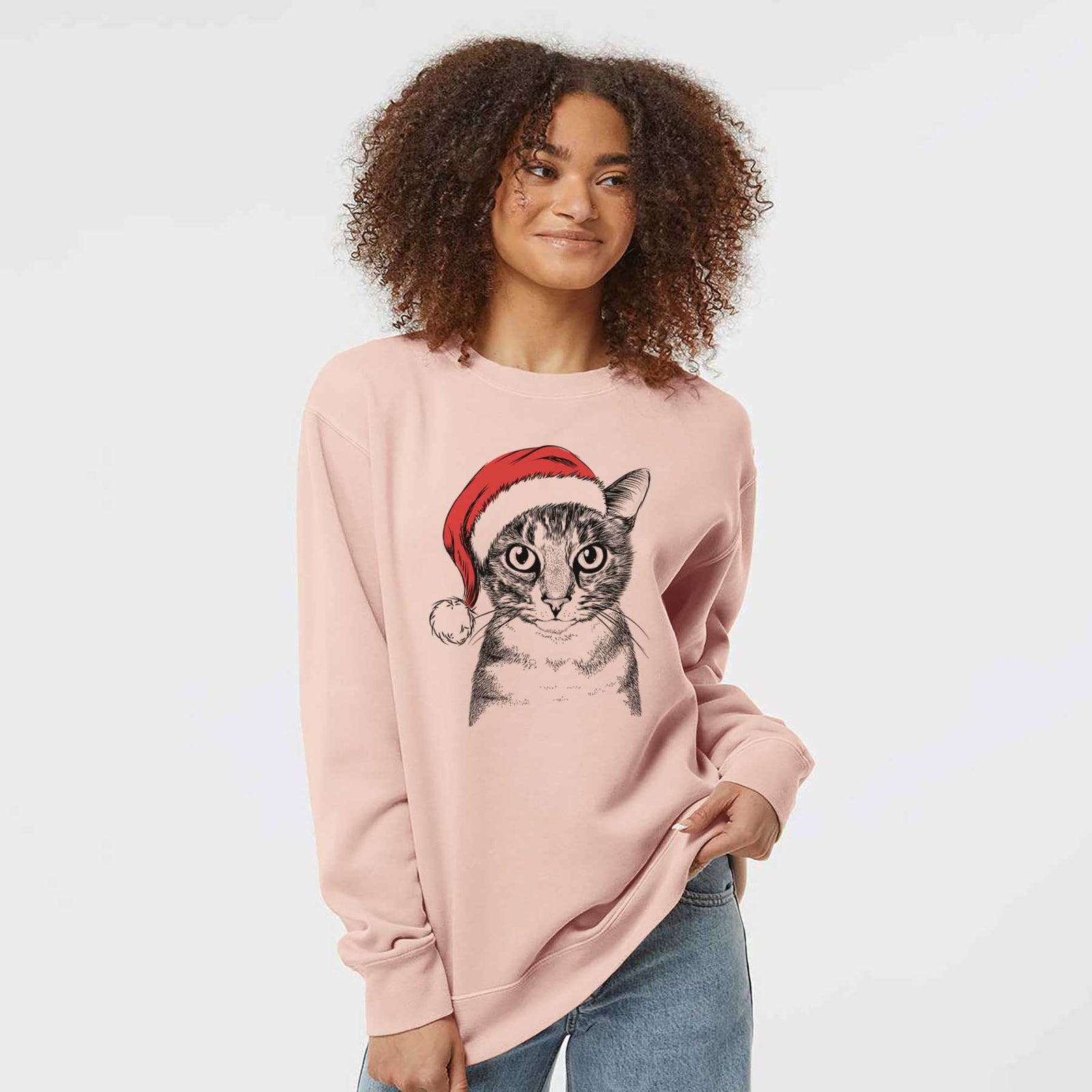 Hand-drawn sketch of Hobbes the Tabby Cat wearing a Santa hat on a Dusty Pink Unisex pigment dyed crew sweatshirt