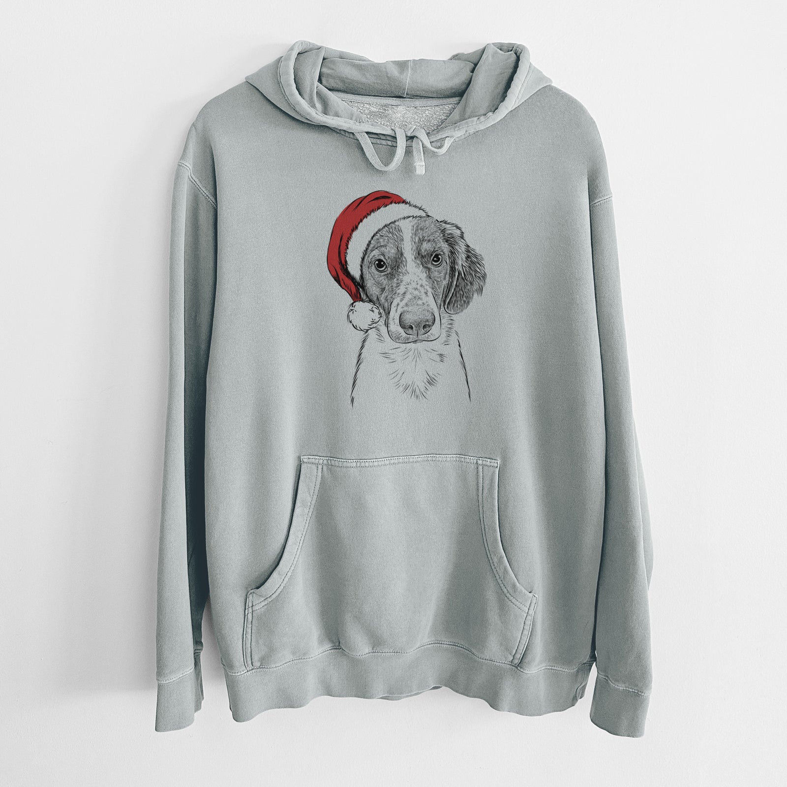 Hand-drawn sketch of Holly the Brittany Spaniel wearing a Santa hat on a Sage Unisex pigment dyed hoodie