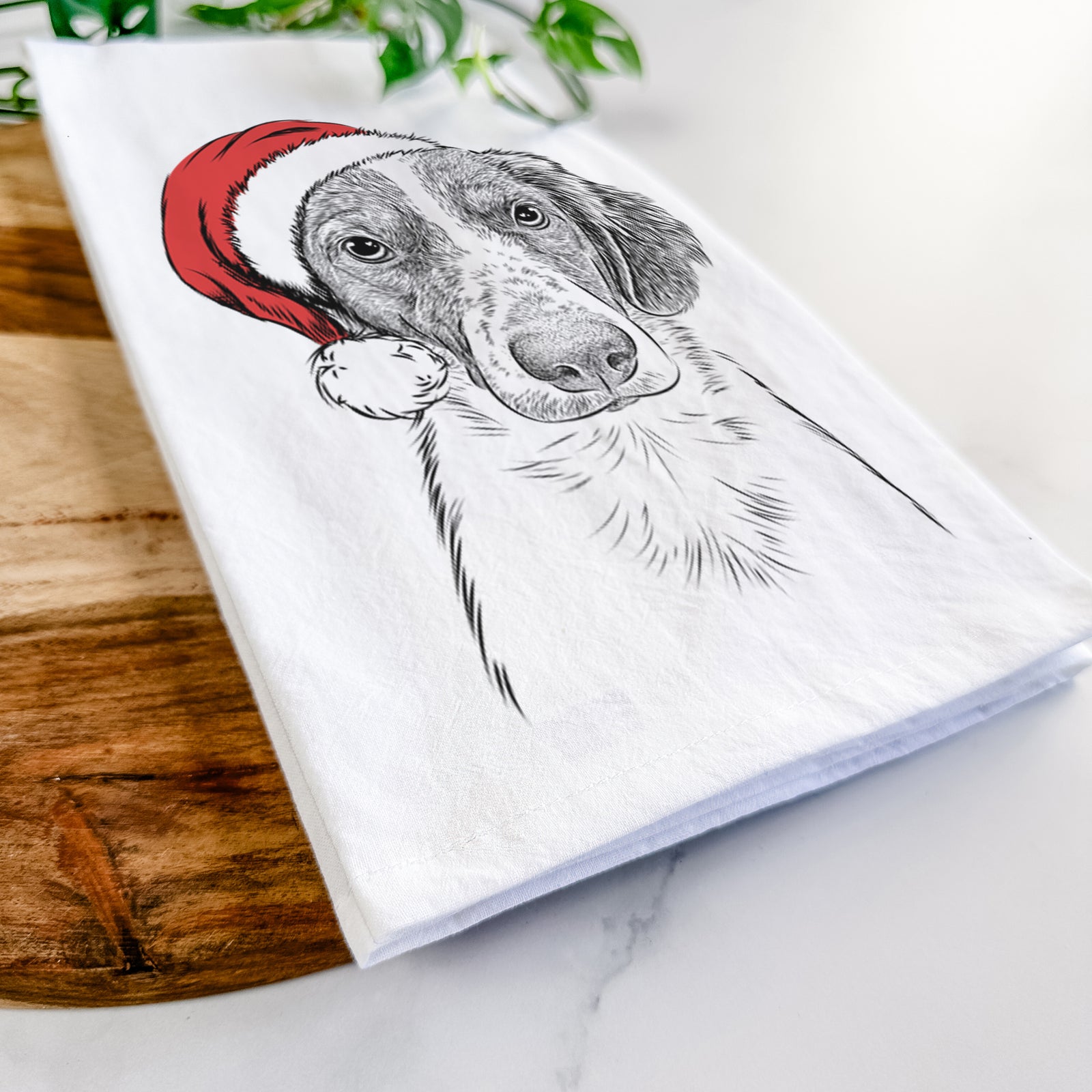 Hand-drawn sketch of Holly the Brittany Spaniel wearing a Santa hat on a tea towel