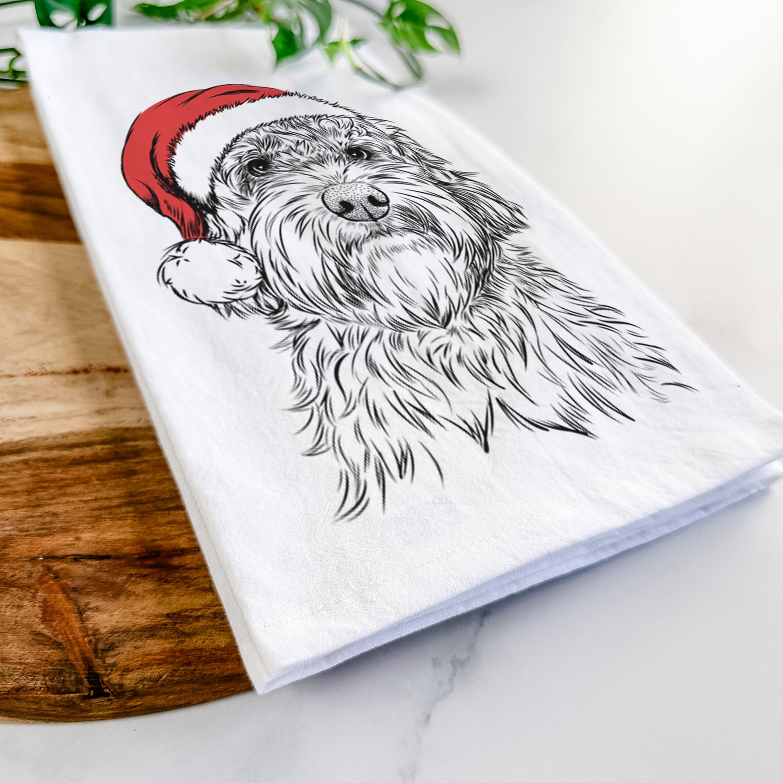 Hand-drawn sketch of Huckleberry the Australian Labradoodle wearing a Santa hat on a tea towel