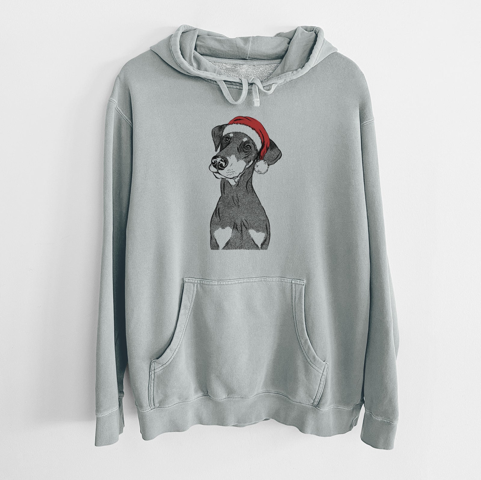 Hand-drawn sketch of Iroh the Doberman Pinscher wearing a Santa hat on a Sage Unisex pigment dyed hoodie