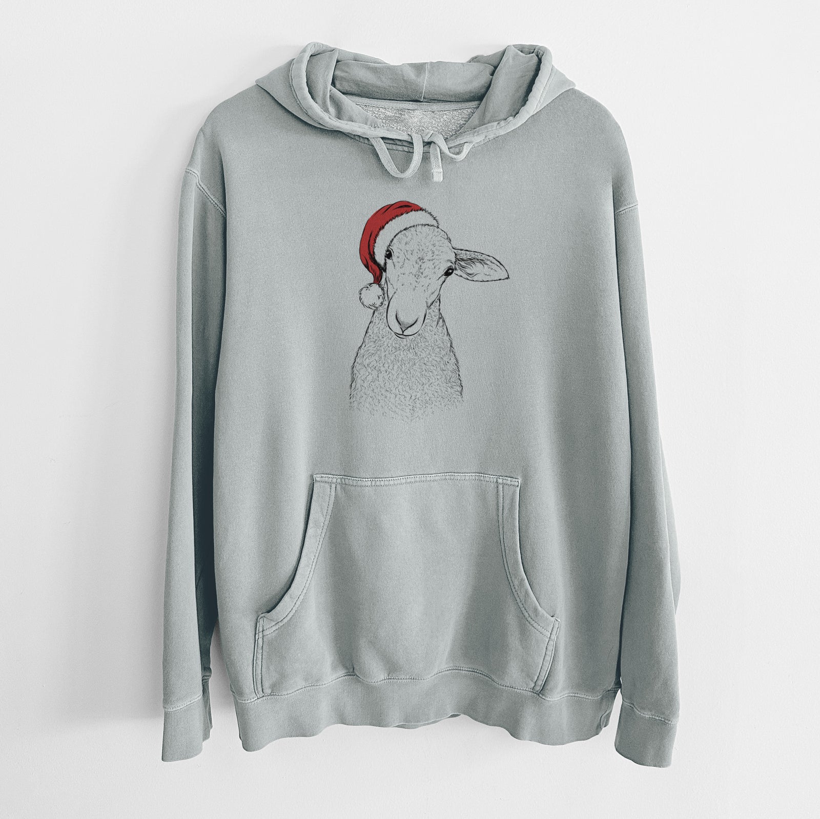 Hand-drawn sketch of Ivy the Lamb wearing a Santa hat on a Sage Unisex pigment dyed hoodie