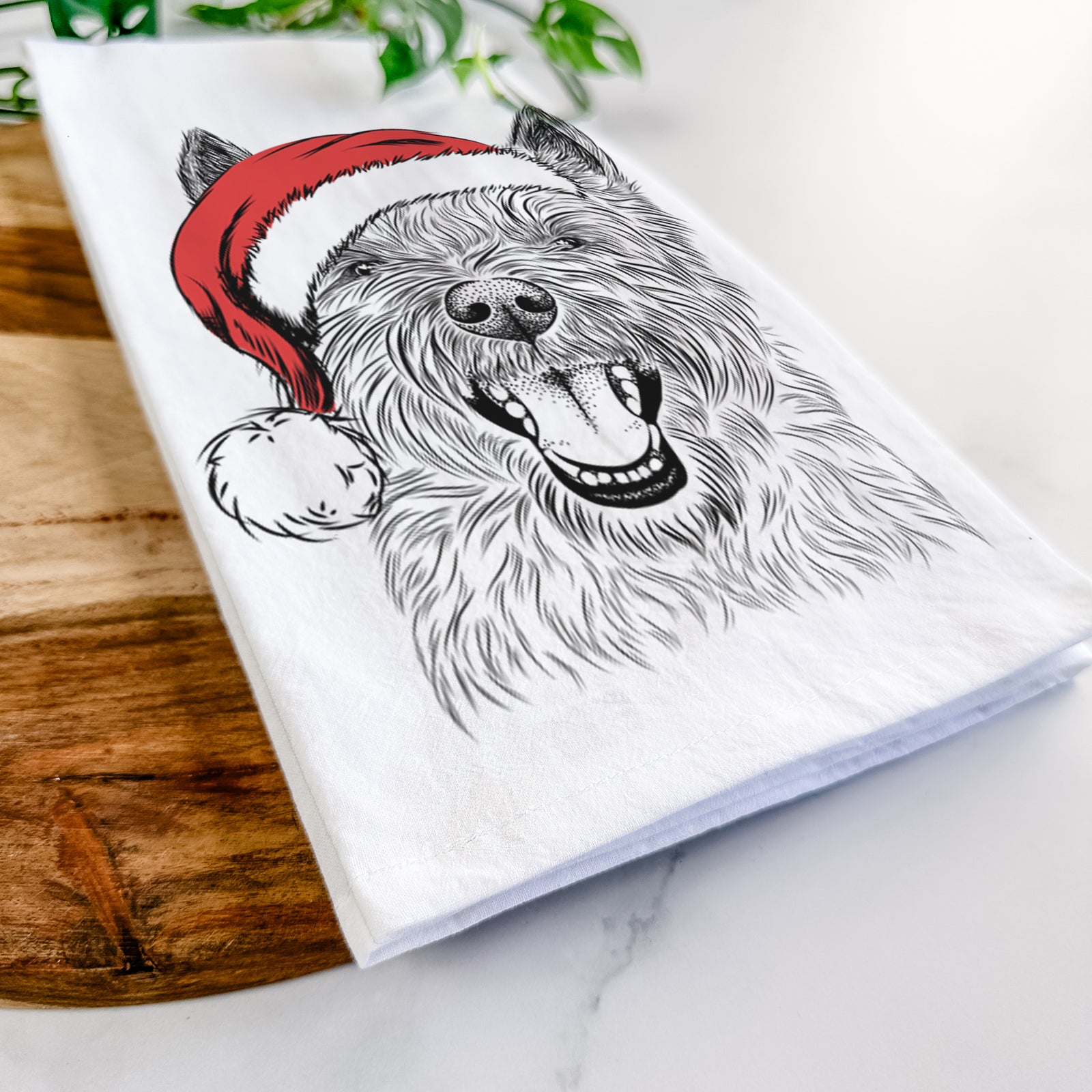 Hand-drawn sketch of Jeff the Cairn Terrier wearing a Santa hat on a tea towel