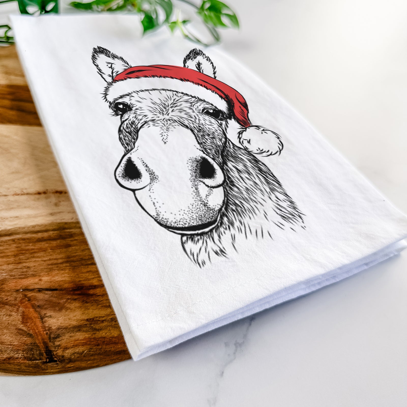 Hand-drawn sketch of Jenny the Donkey wearing a Santa hat on a tea towel