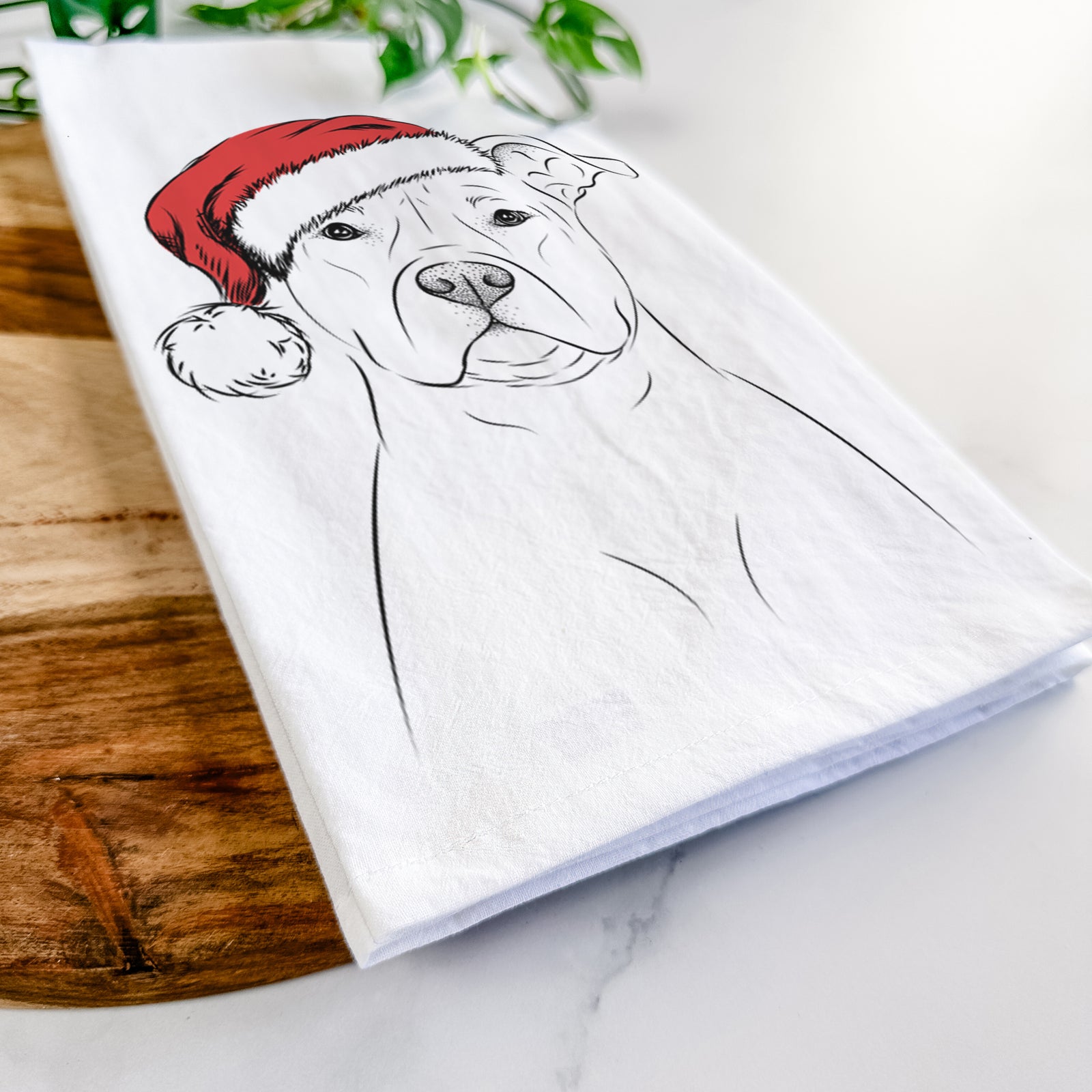 Hand-drawn sketch of Jethro the American Staffordshire Terrier wearing a Santa hat on a tea towel