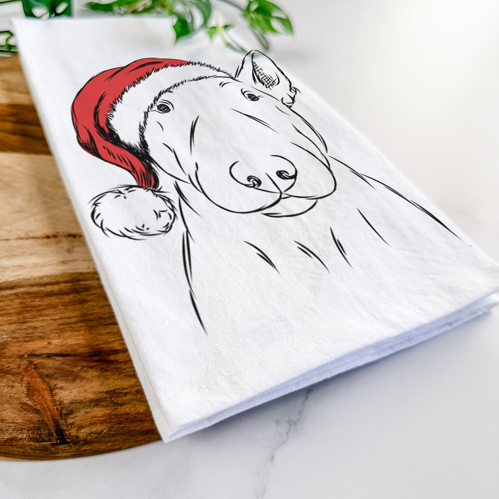 Hand-drawn sketch of Jett the Bull Terrier wearing a Santa hat on a tea towel