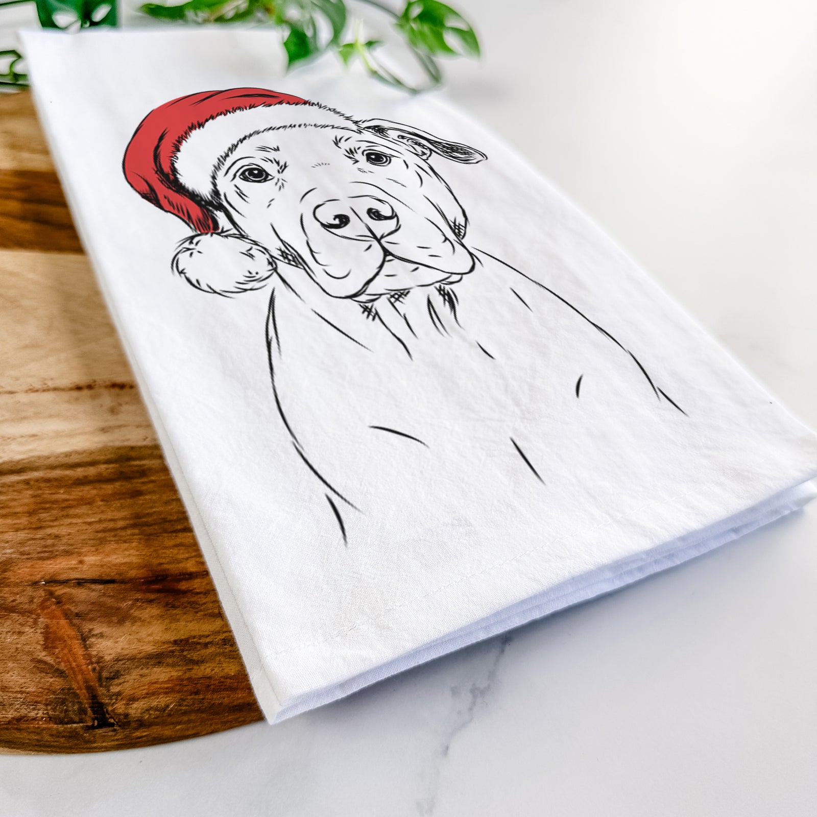 Hand-drawn sketch of Kadin the Pitbull wearing a Santa hat on a tea towel