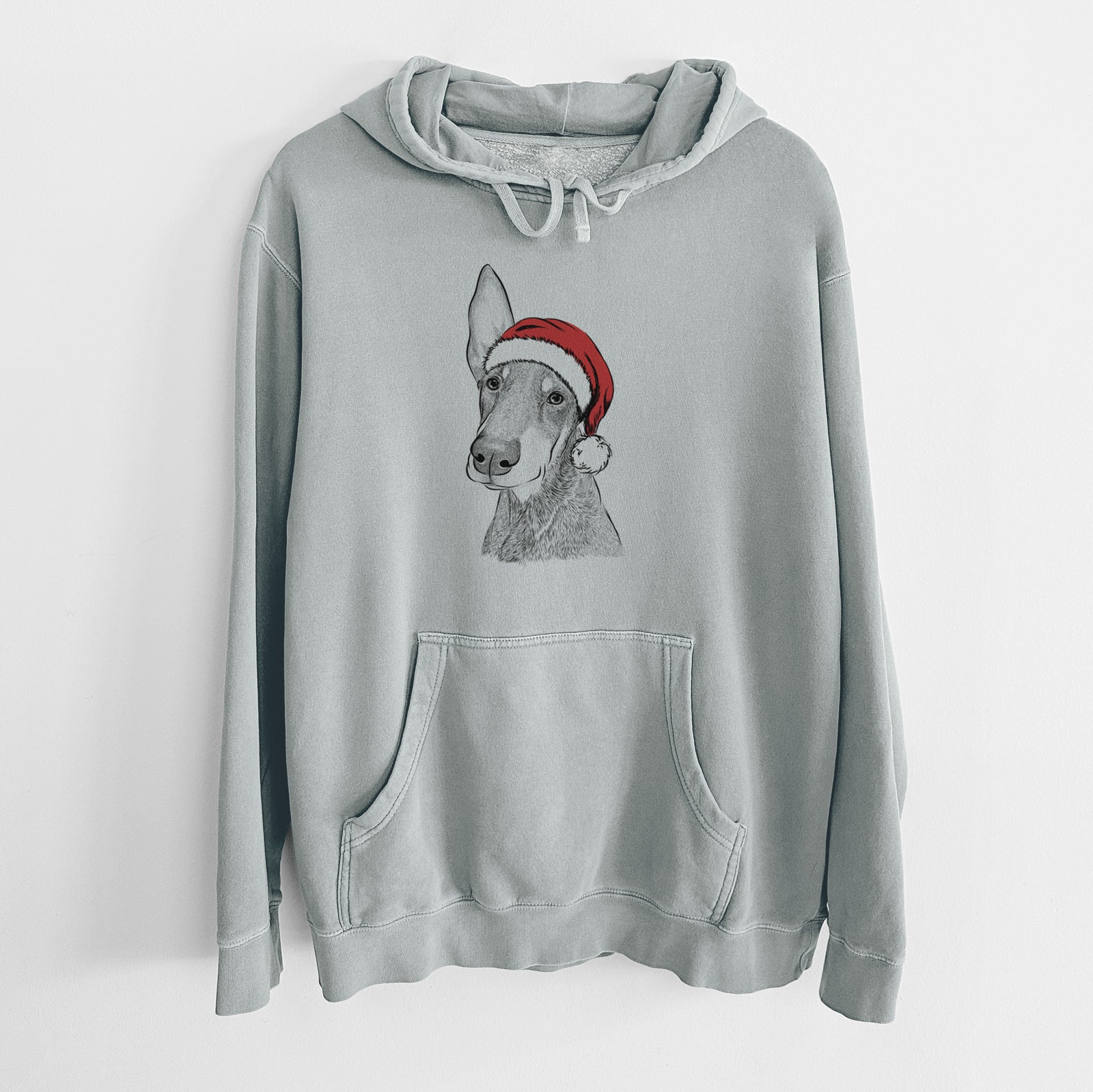 Hand-drawn sketch of Kain the Doberman Pinscher wearing a Santa hat on a Sage Unisex pigment dyed hoodie