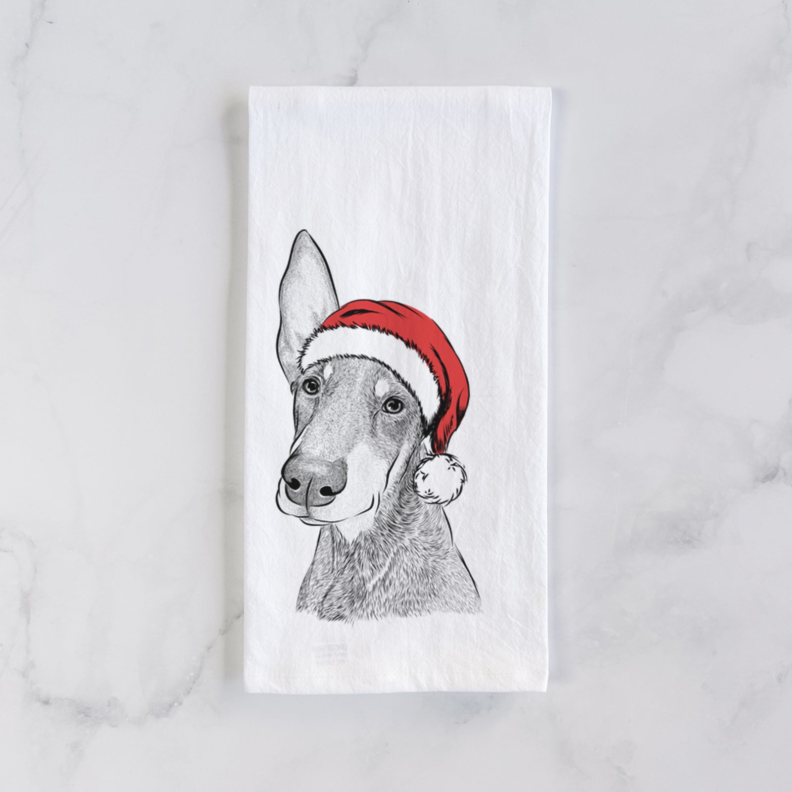 Hand-drawn sketch of Kain the Doberman Pinscher wearing a Santa hat on a tea towel