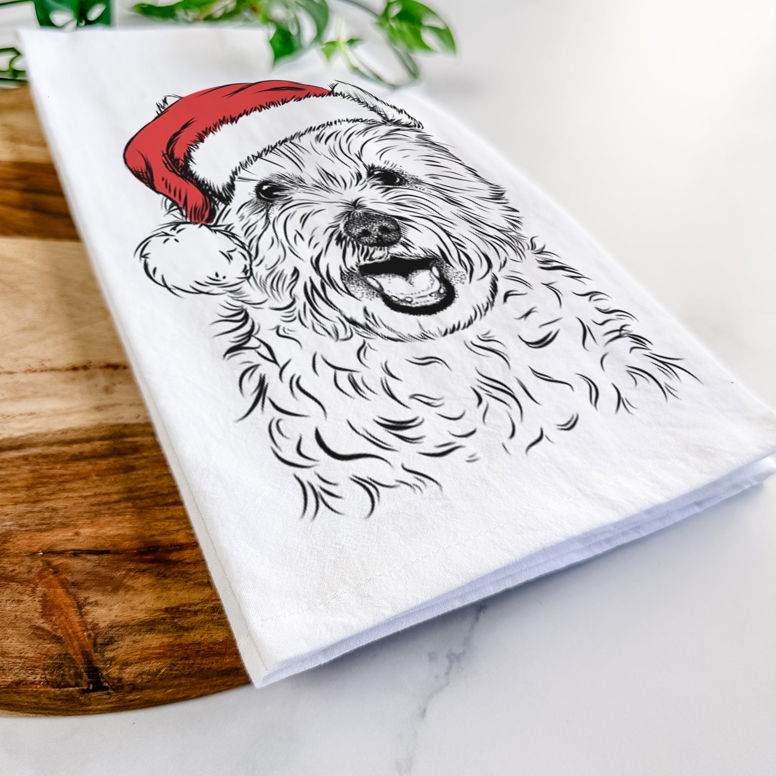 Hand-drawn sketch of Kami the West Highland Terrier wearing a Santa hat on a tea towel