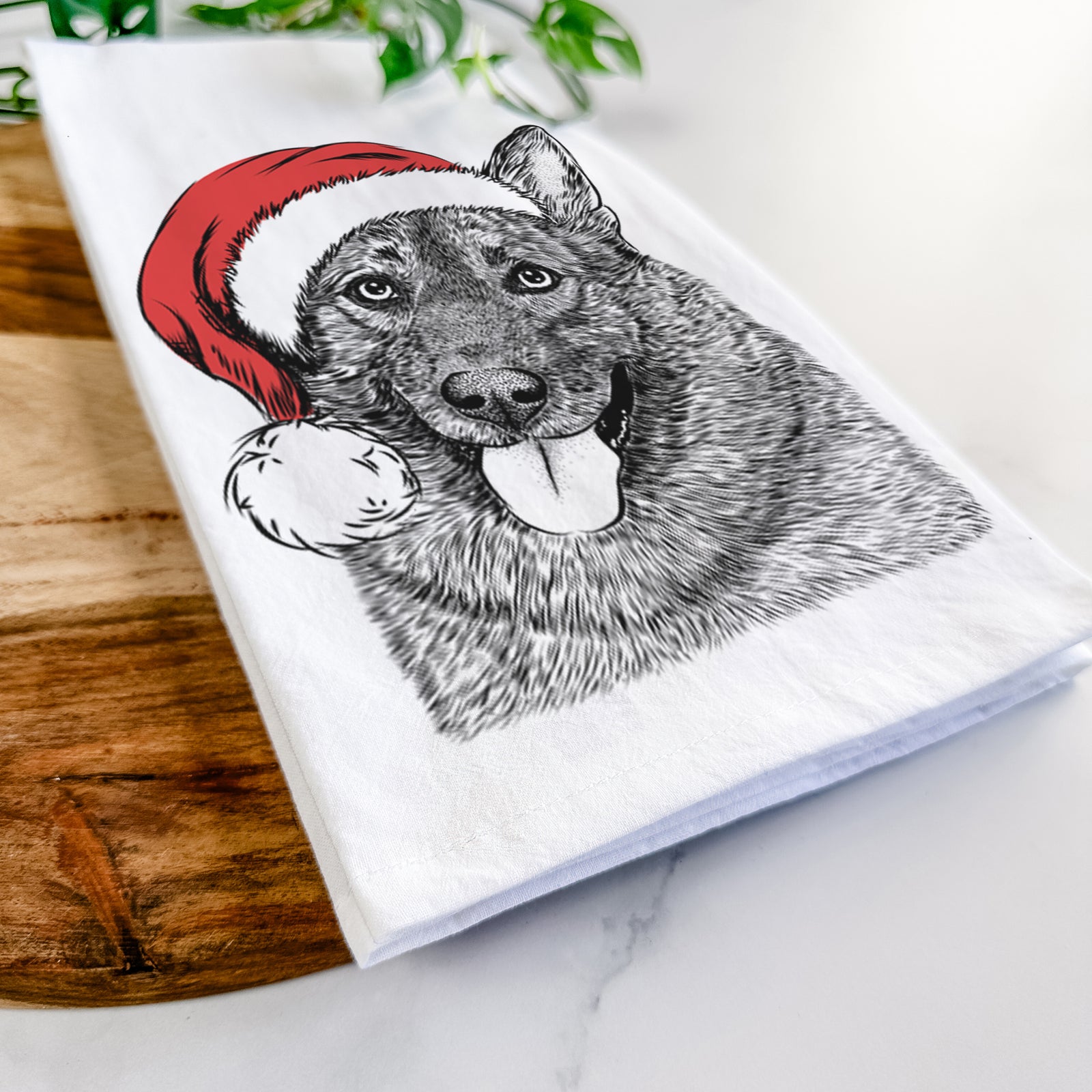 Hand-drawn sketch of Kasia the Norwegian Elkhound wearing a Santa hat on a tea towel