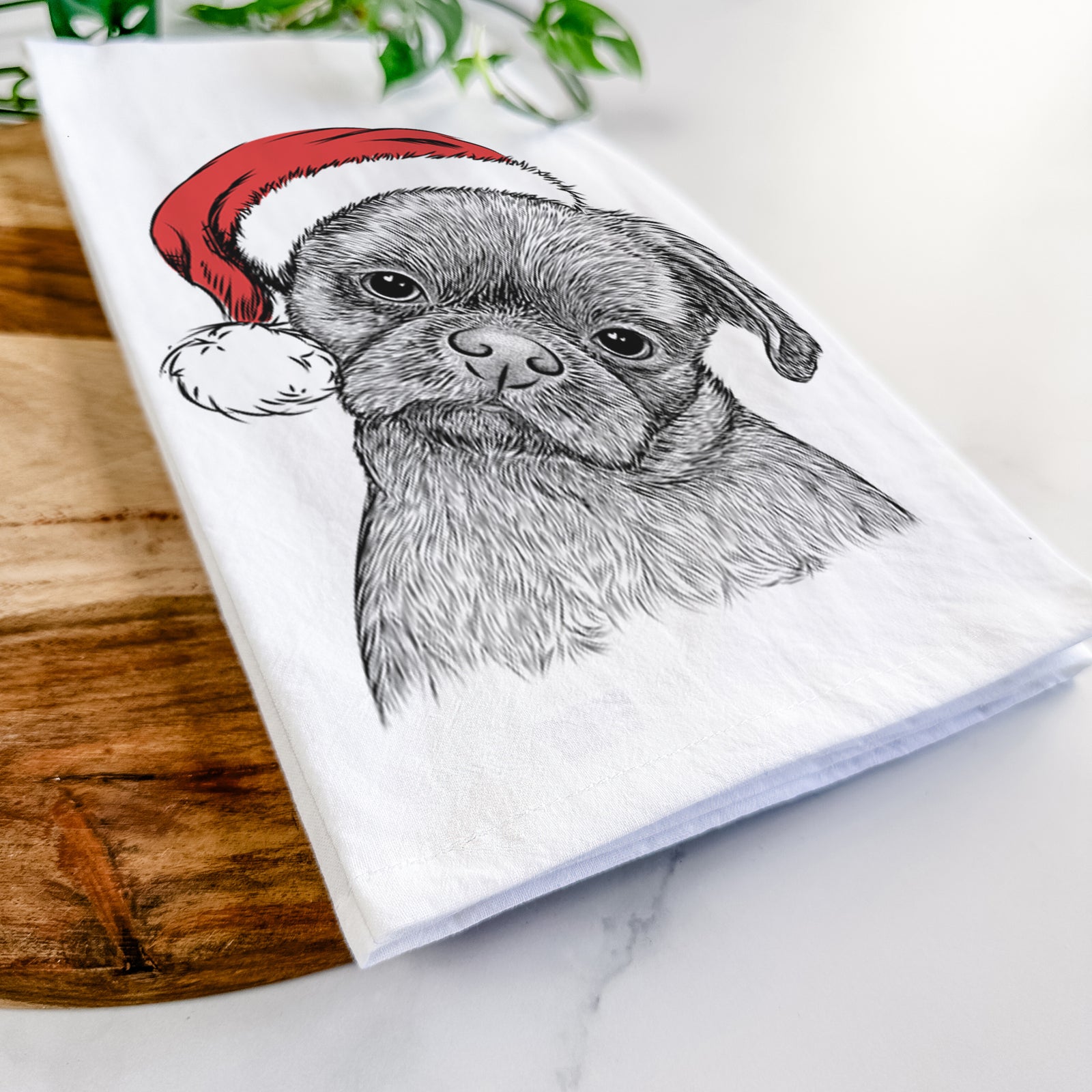 Hand-drawn sketch of Koko the Shih Tzu wearing a Santa hat on a tea towel