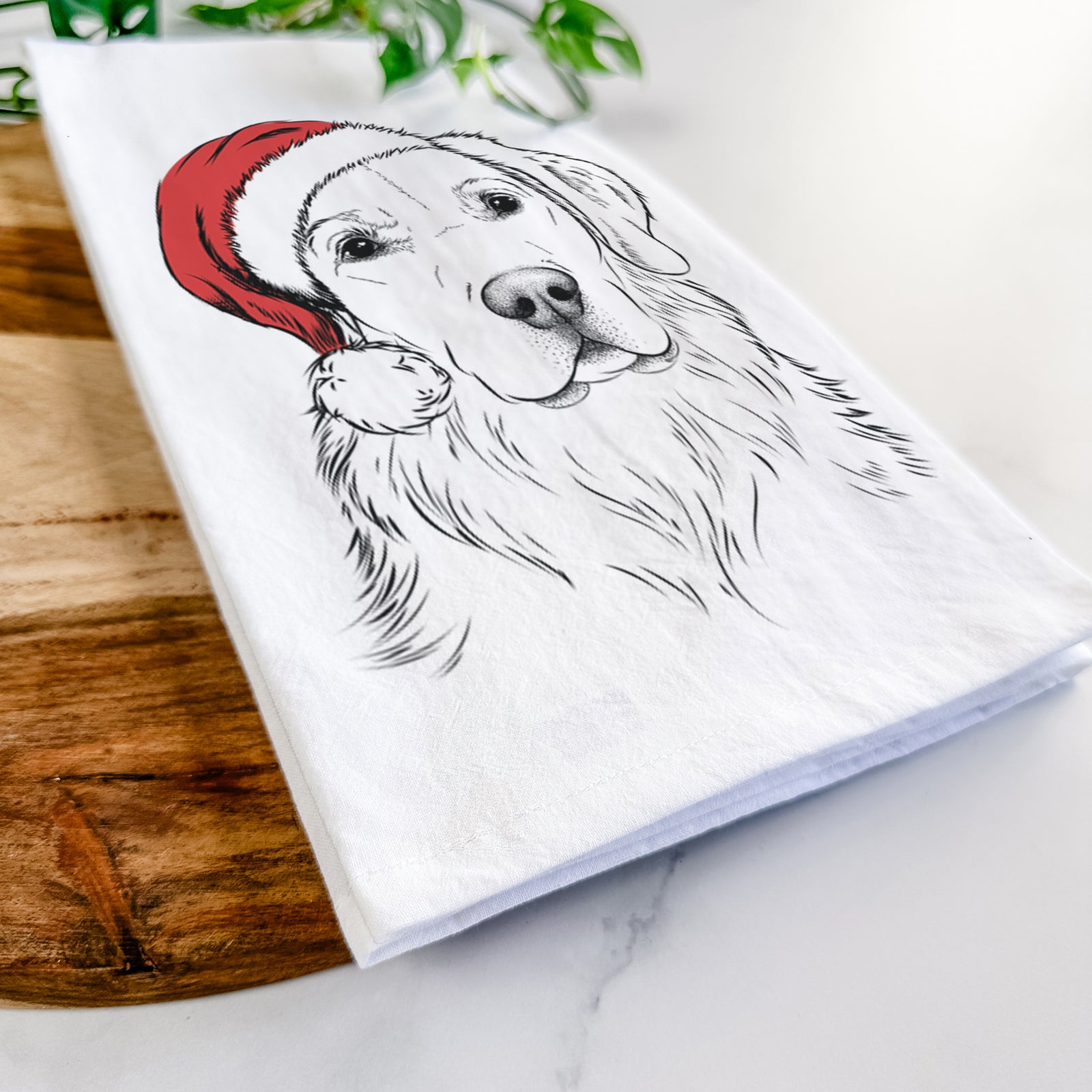 Hand-drawn sketch of Kula the Golden Retriever wearing a Santa hat on a tea towel